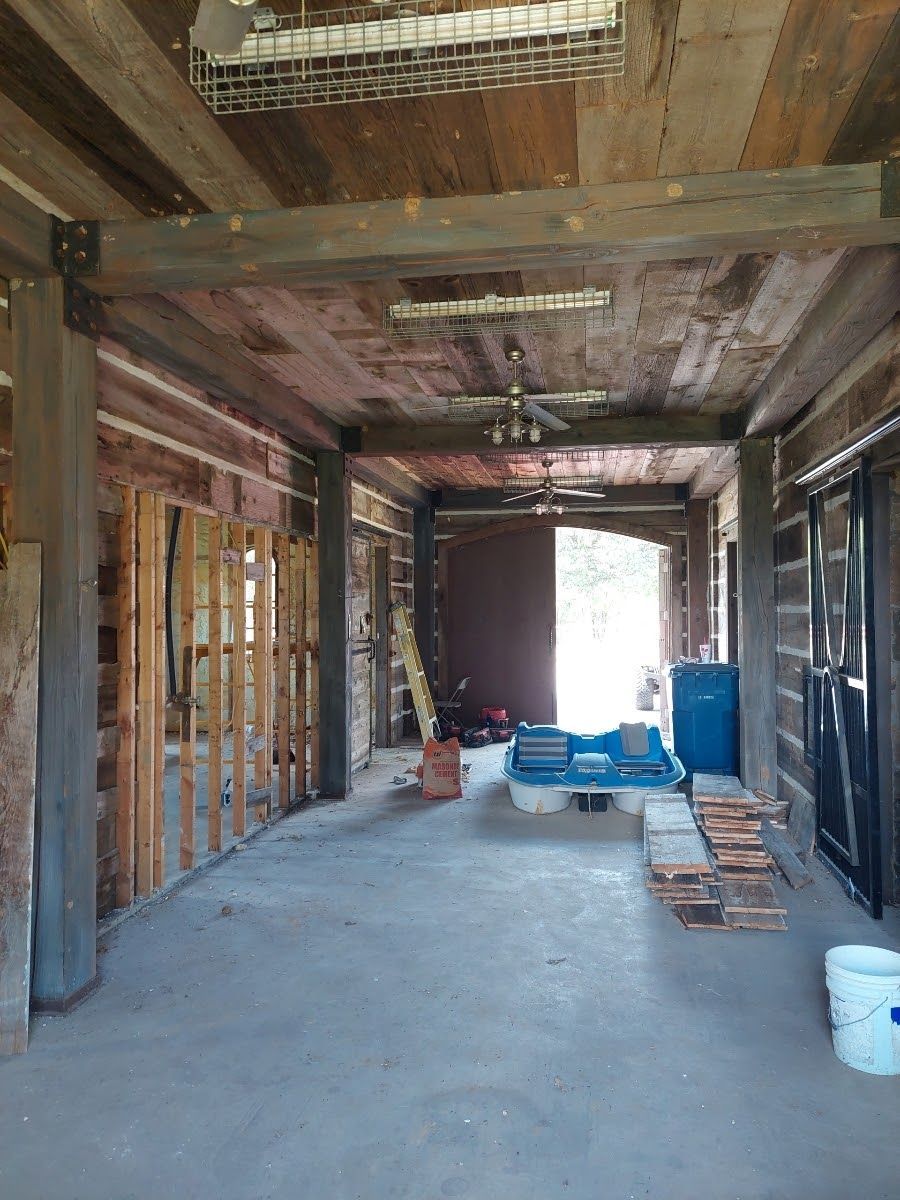 a large room with a wooden ceiling and a bucket on the floor .
