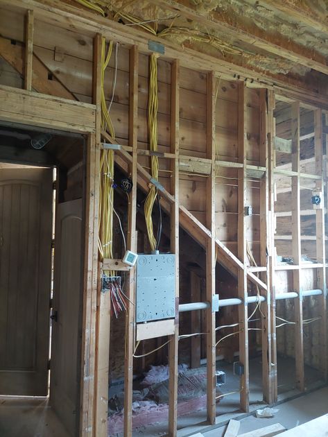 a house is being built with a lot of wood and wires