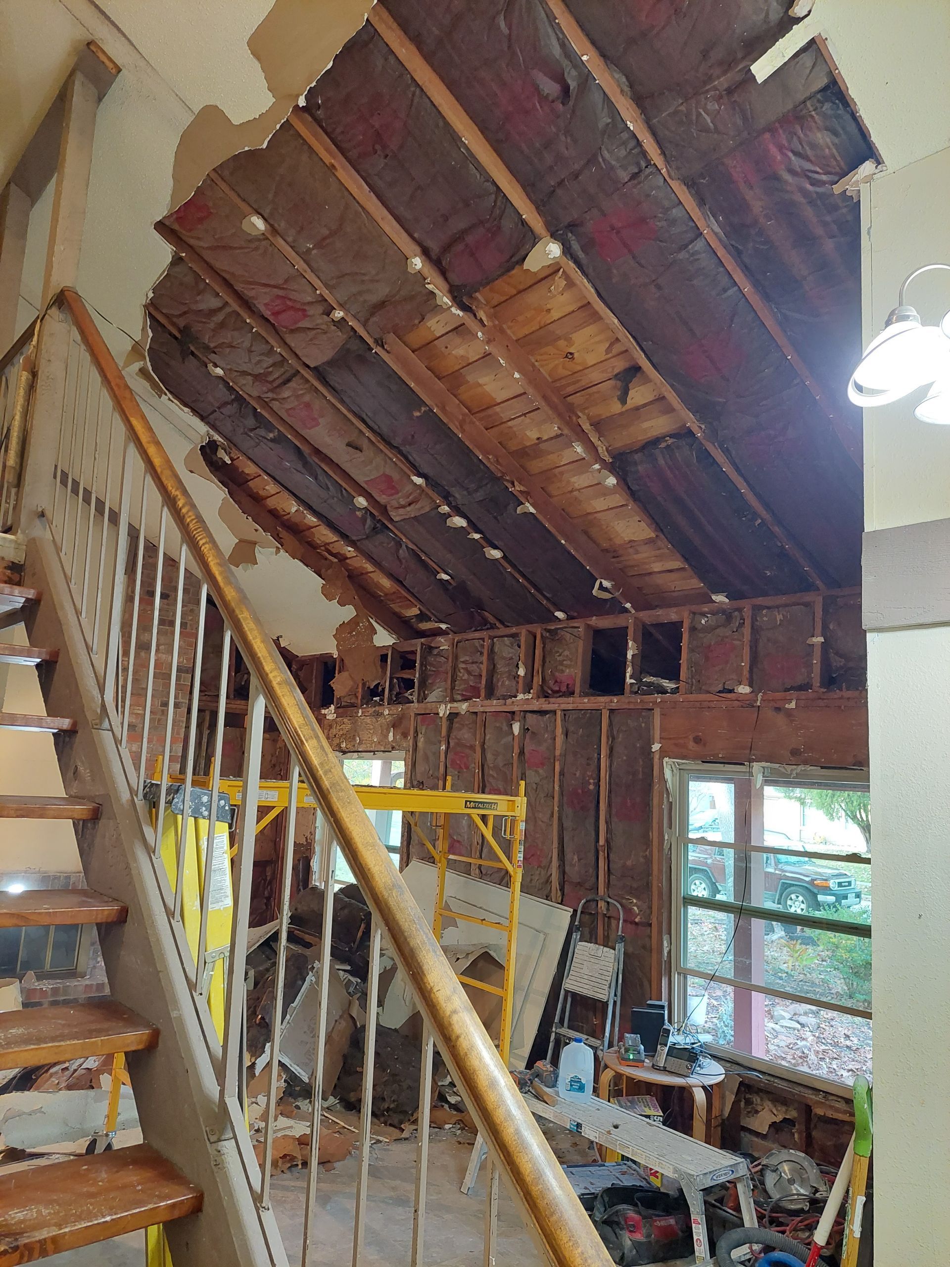 a staircase leading up to an attic in a house under construction .