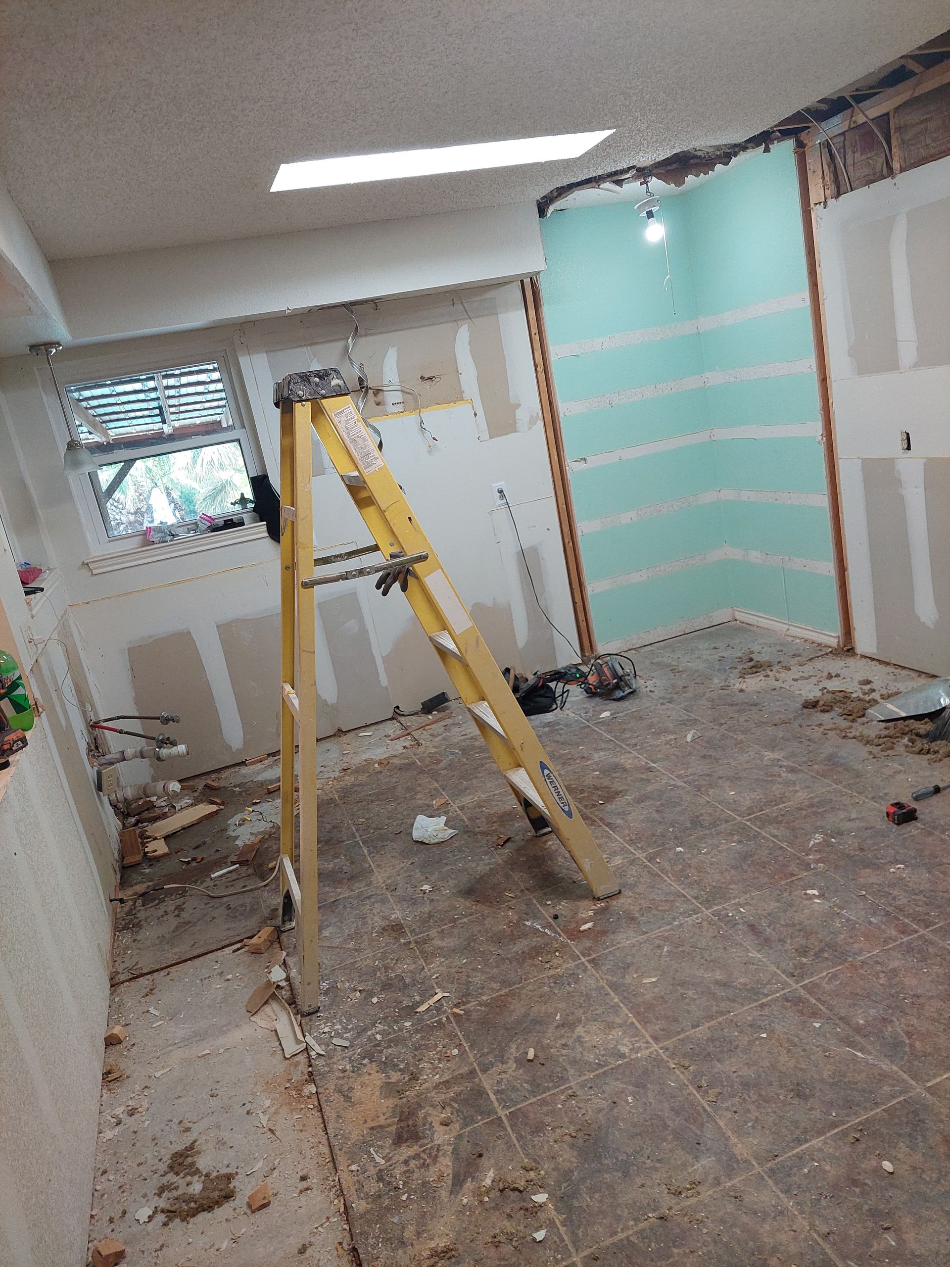 a yellow ladder is sitting in the middle of a room .