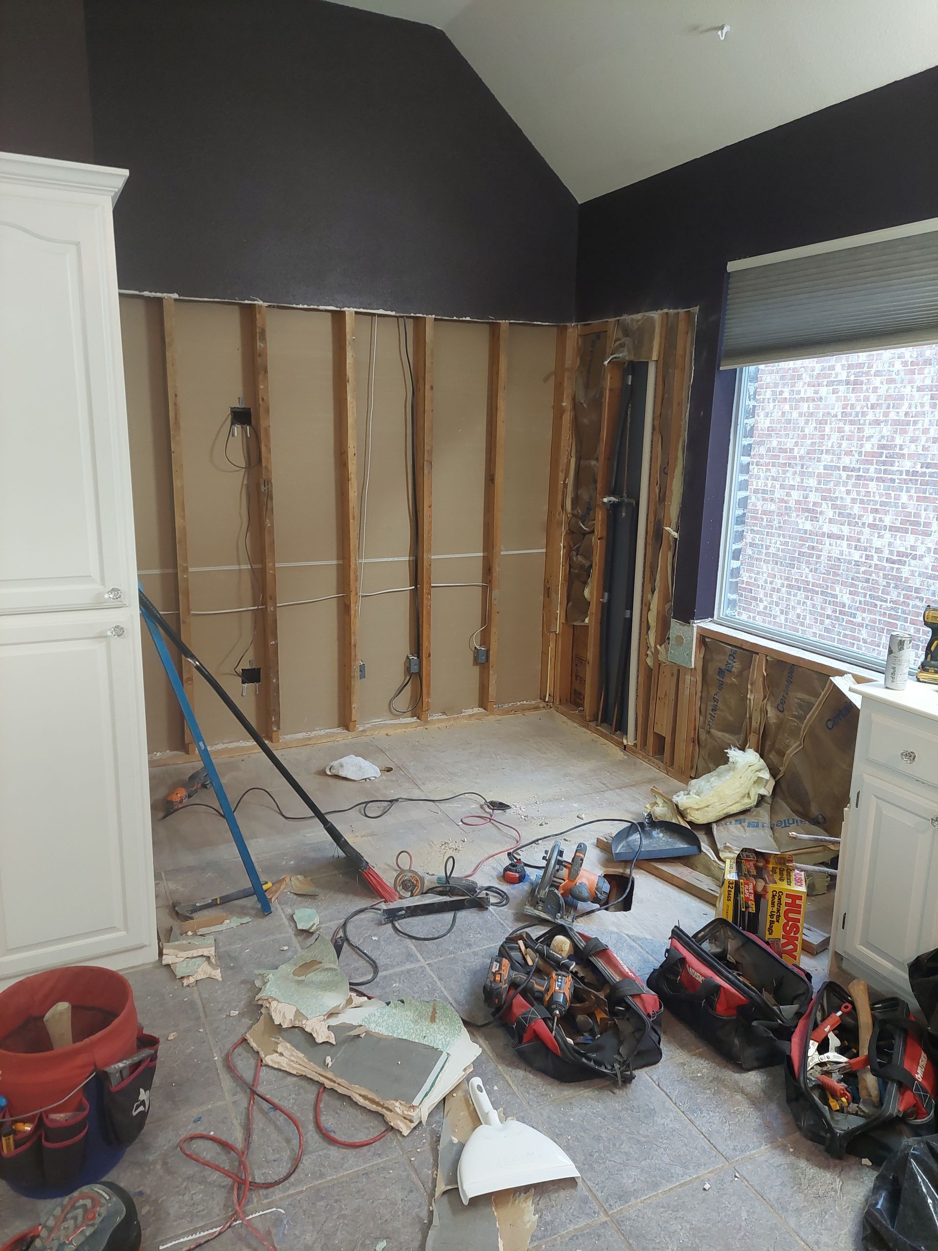 a room that is being remodeled with a lot of tools on the floor .