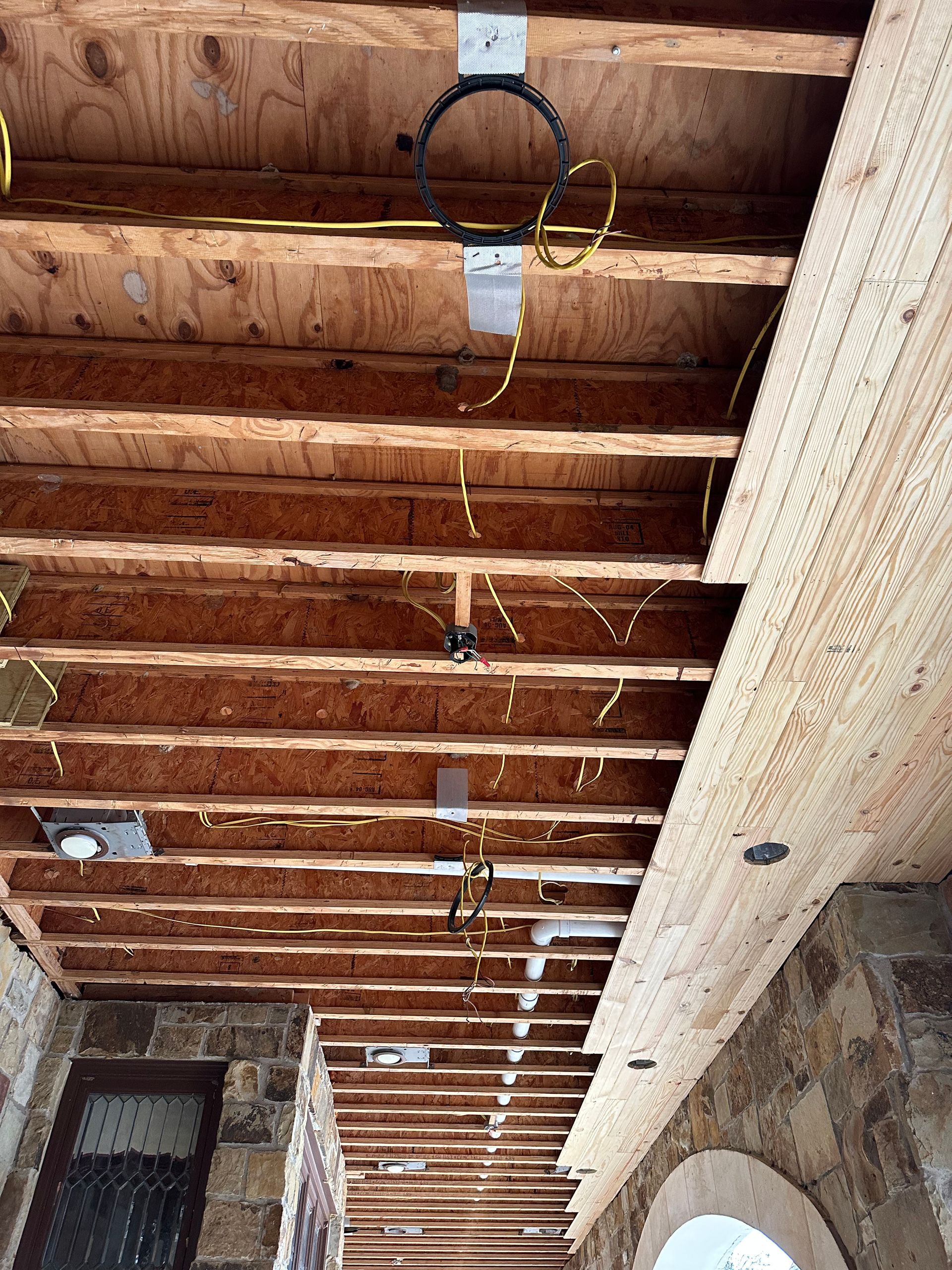 a wooden ceiling with a lot of wires hanging from it