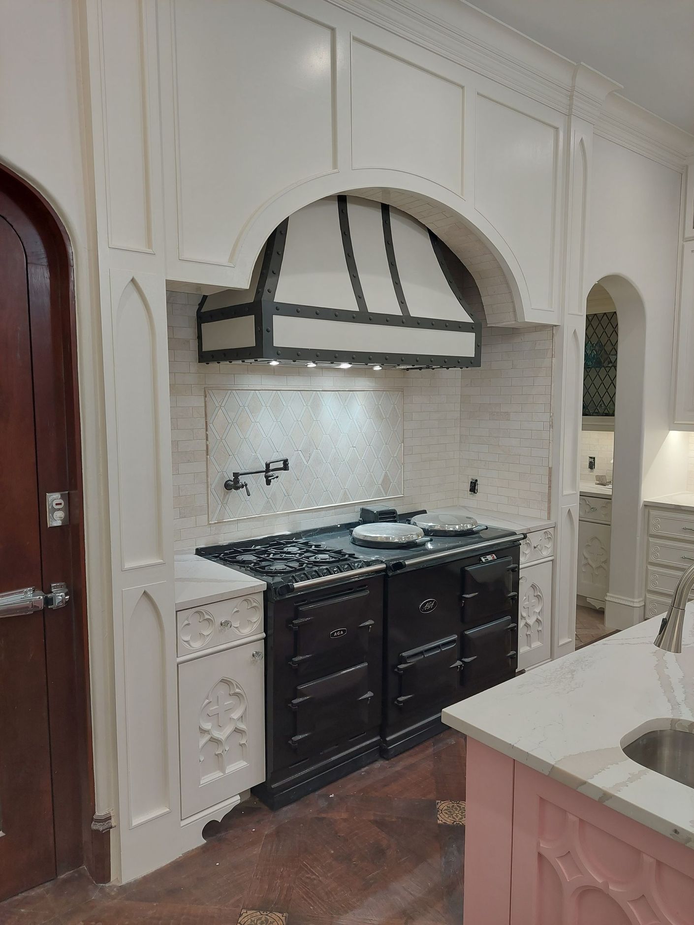 a kitchen with a stove top oven and a sink