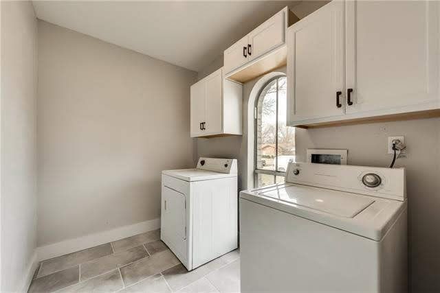 a kitchen with white cabinets and a large island
