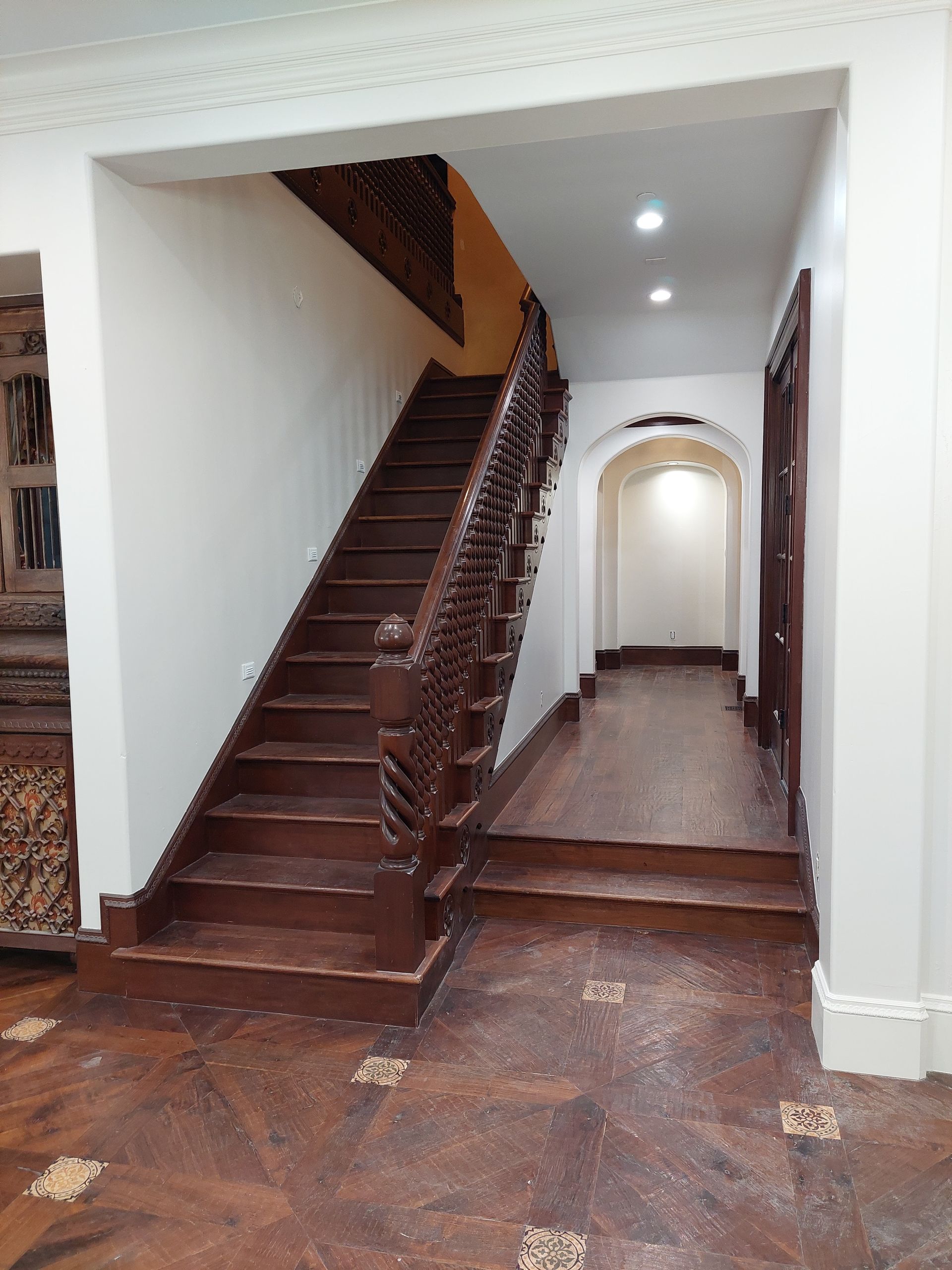 a hallway with stairs leading up to the second floor