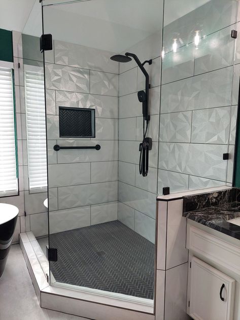 a bathroom with a walk in shower and a sink