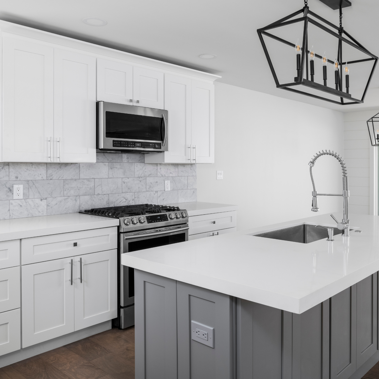 a kitchen with white cabinets and a large island