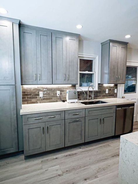 a kitchen with white cabinets and a large island