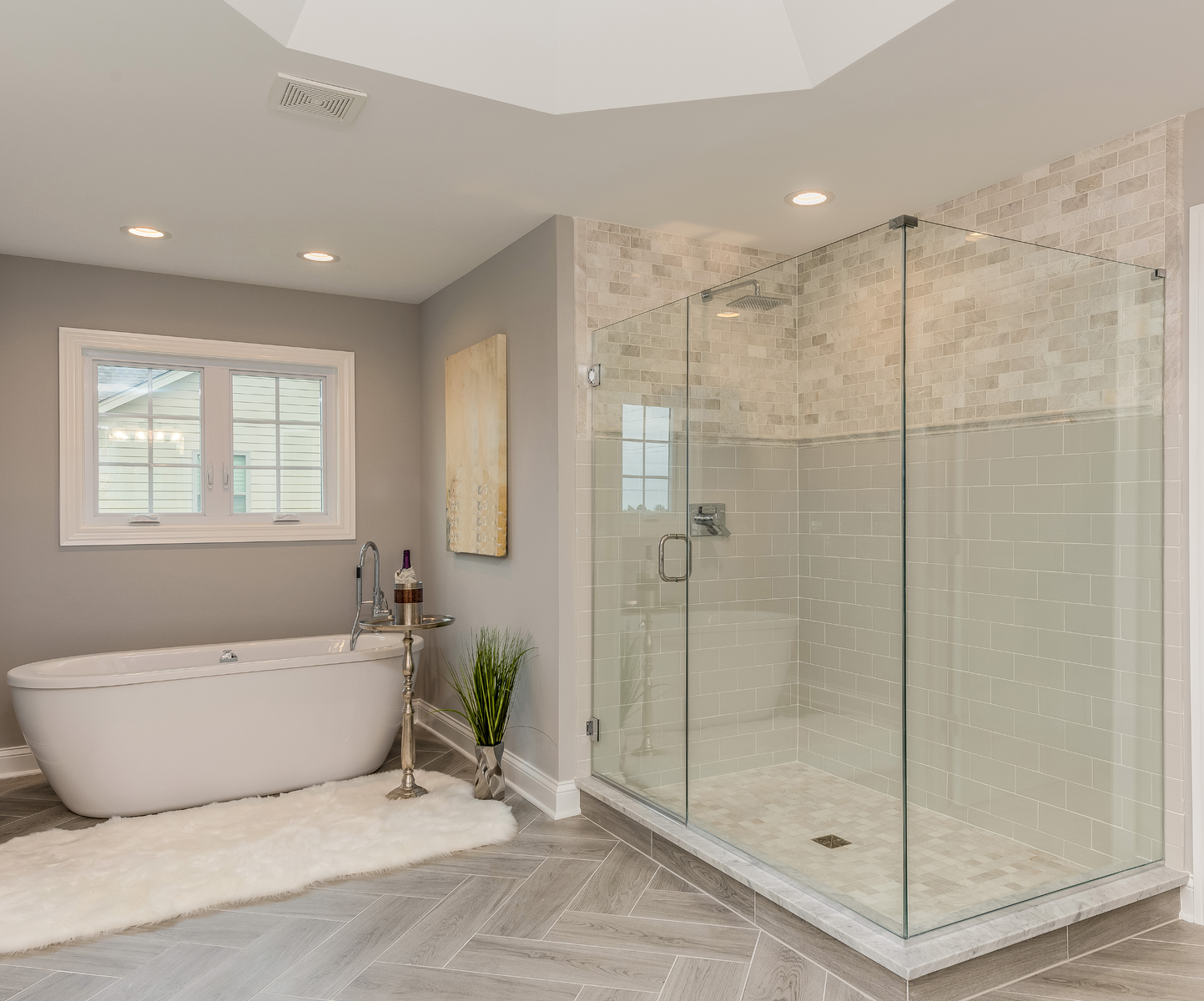 a bathroom with a bathtub and a walk in shower .