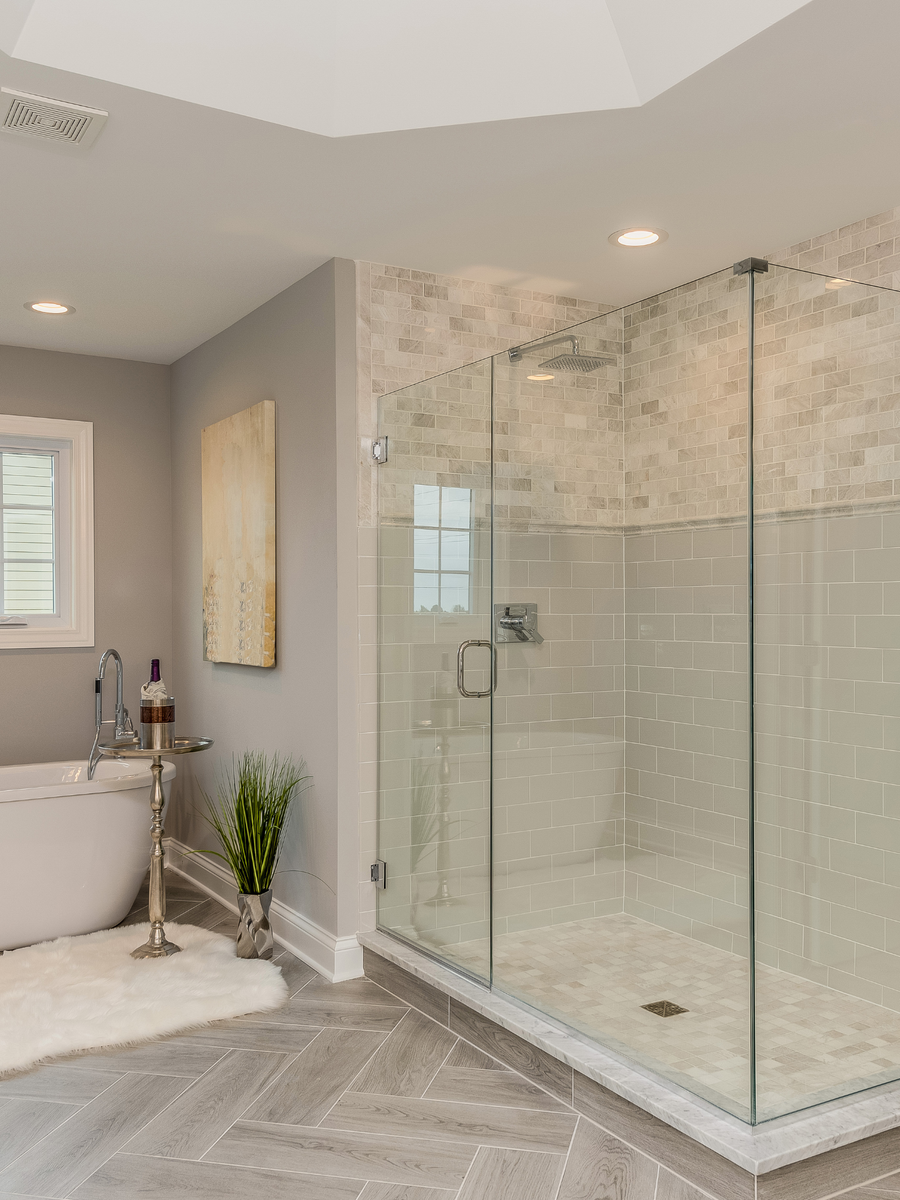 a bathroom with a bathtub and a walk in shower .