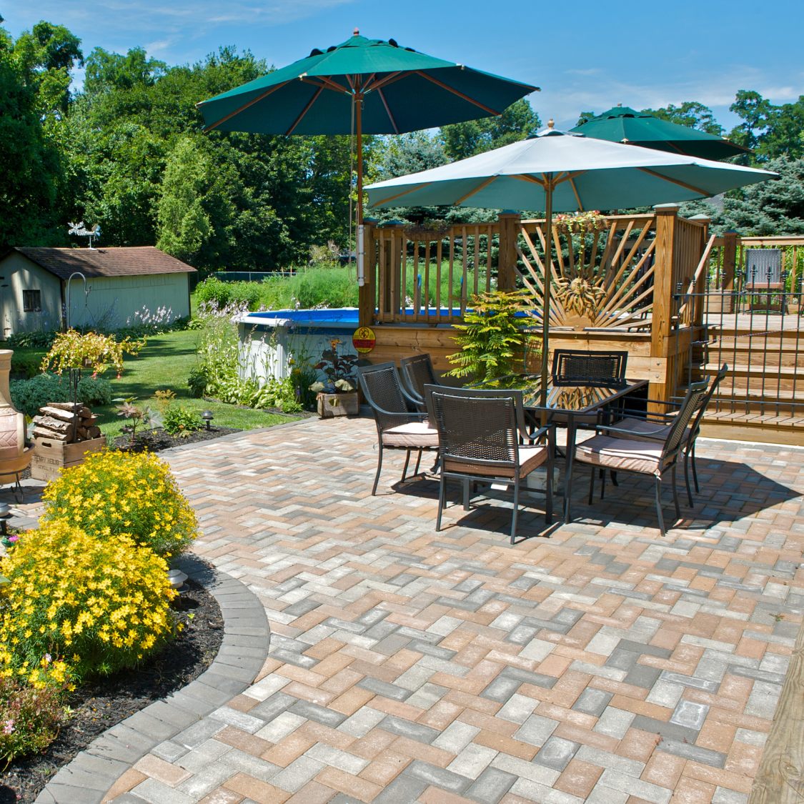 a patio with a table and chairs and umbrellas