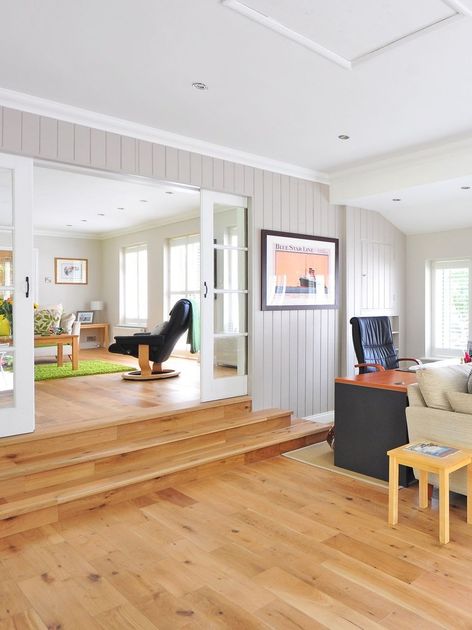 a living room with hardwood floors and a couch and chair .