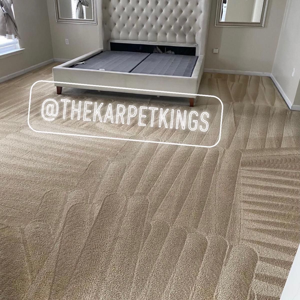 Beige carpet in a bedroom with a white upholstered bed and two mirrors. 