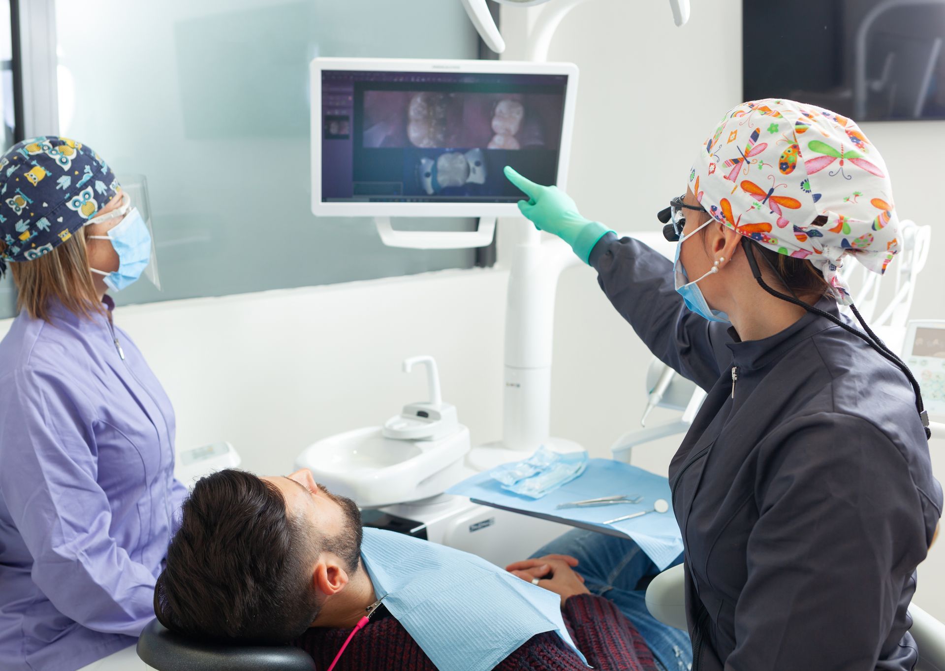 Dentist showing X-ray of infected tooth for root canal treatment
