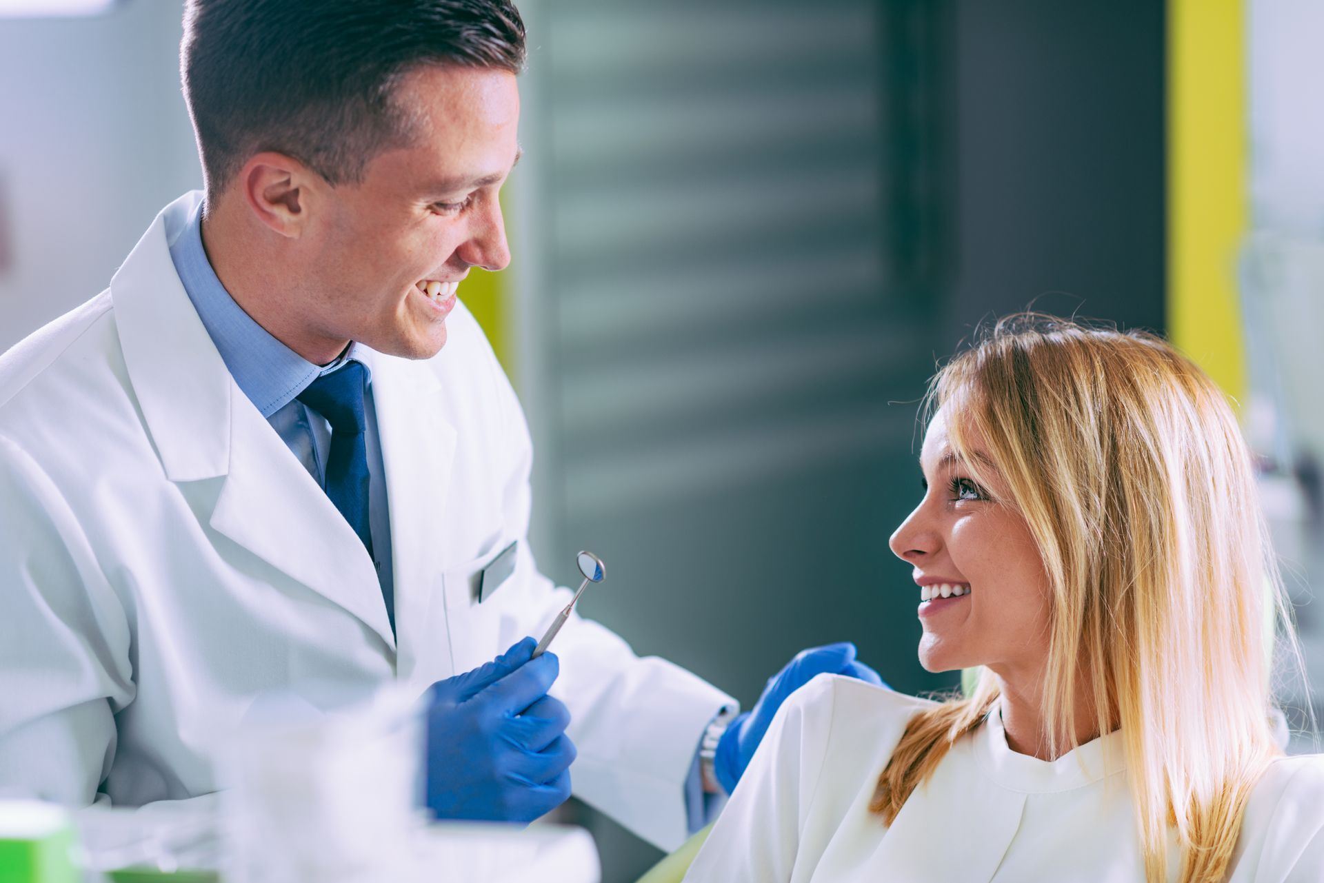 Dentist discussing tooth restoration and extraction options with a patient