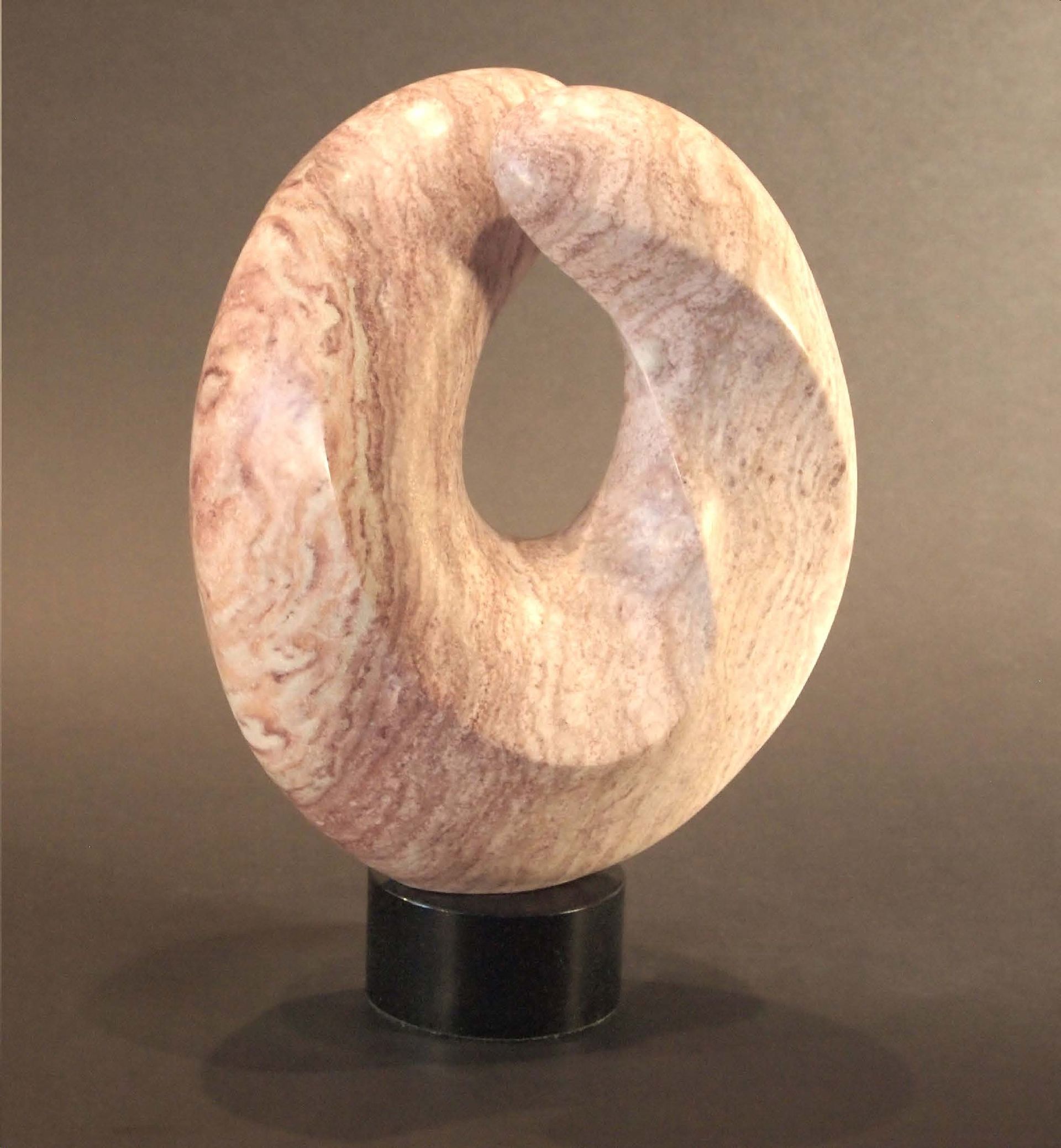 A wooden sculpture with a hole in the middle