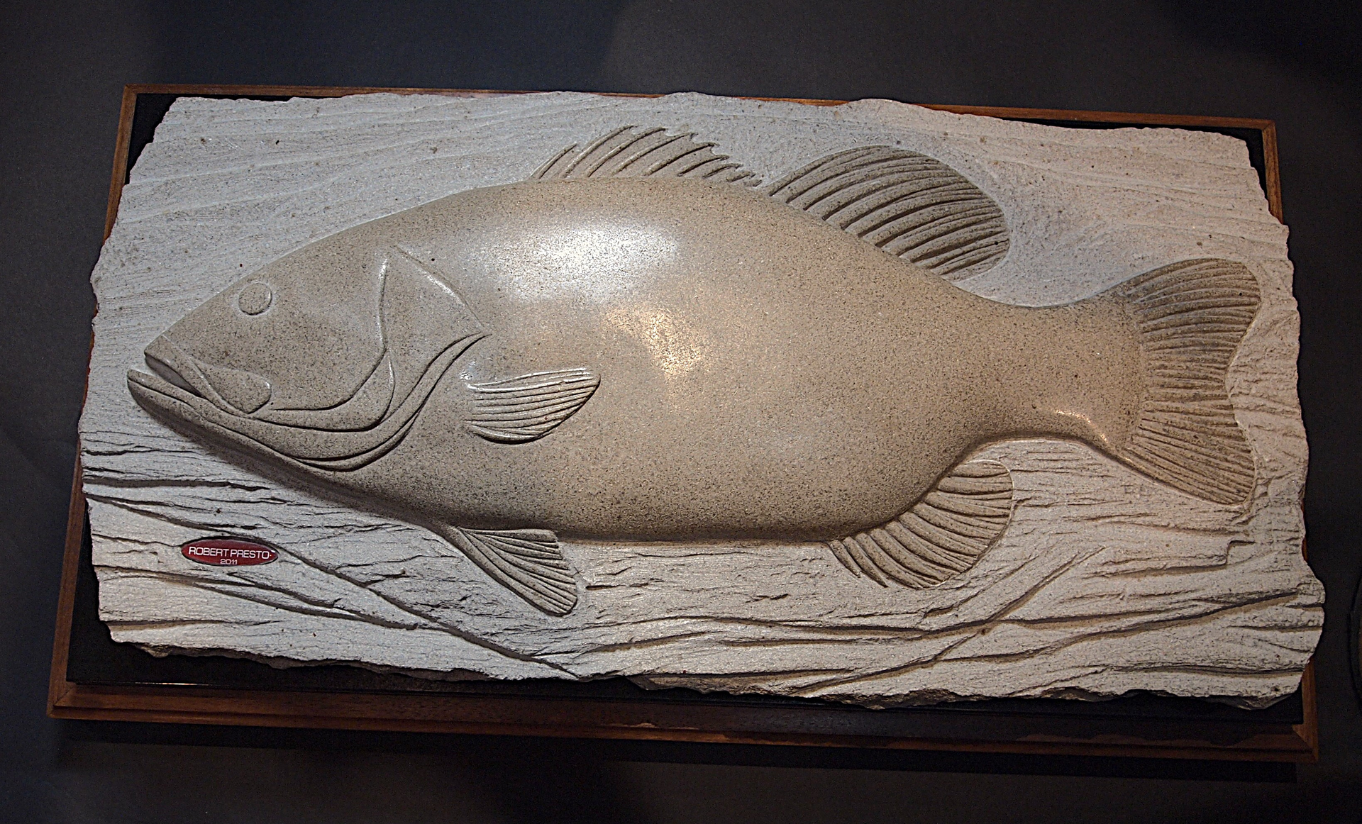 A fish is carved into a piece of wood