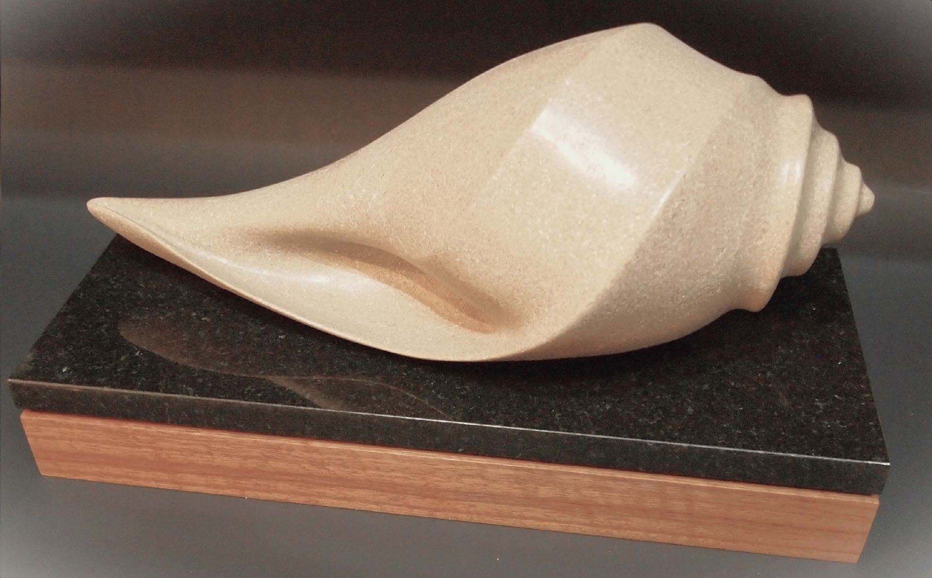 A sculpture of a swirl on a black base