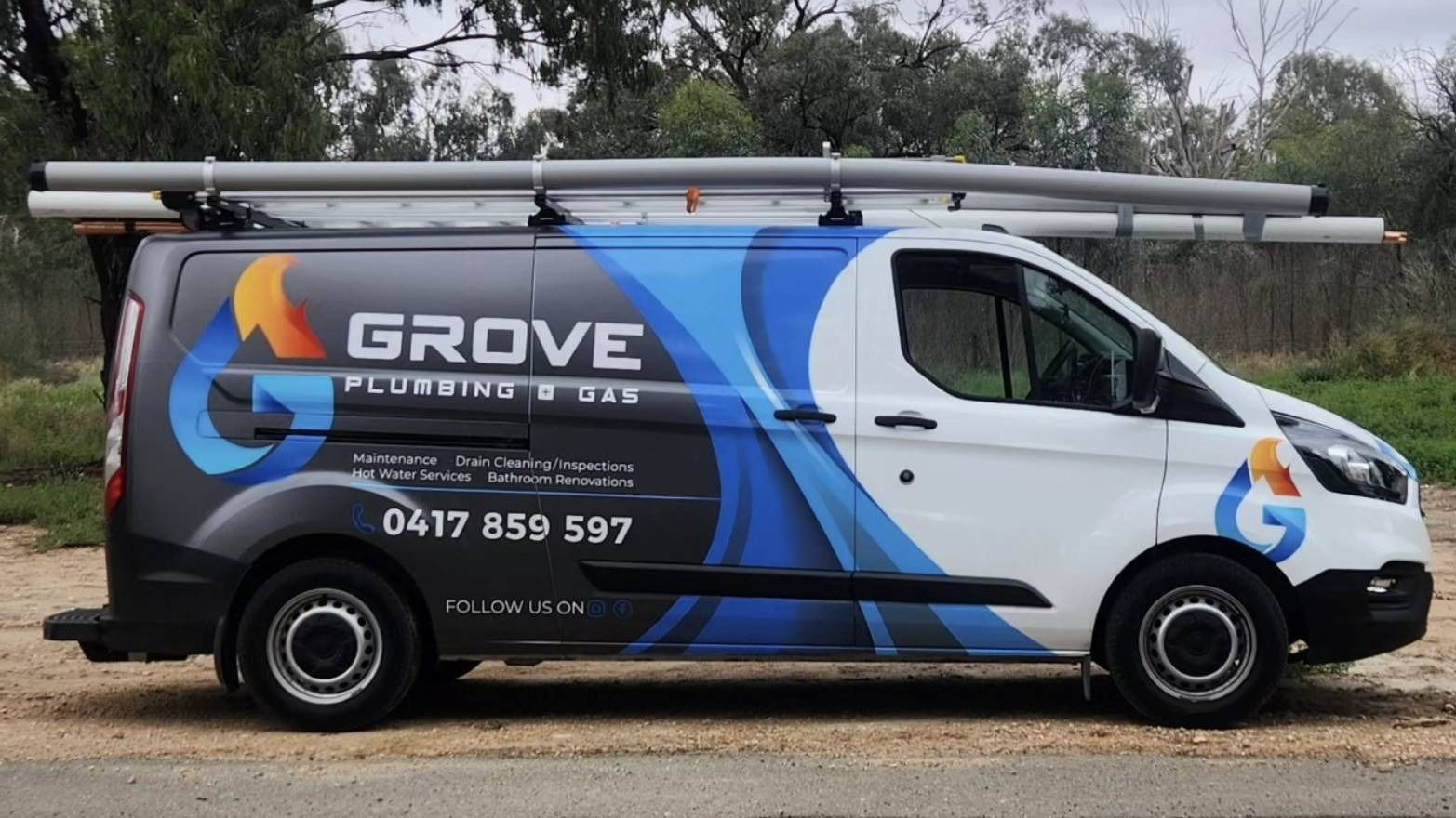 White service van with GROVE roofing branding parked outdoors beside trees and a road