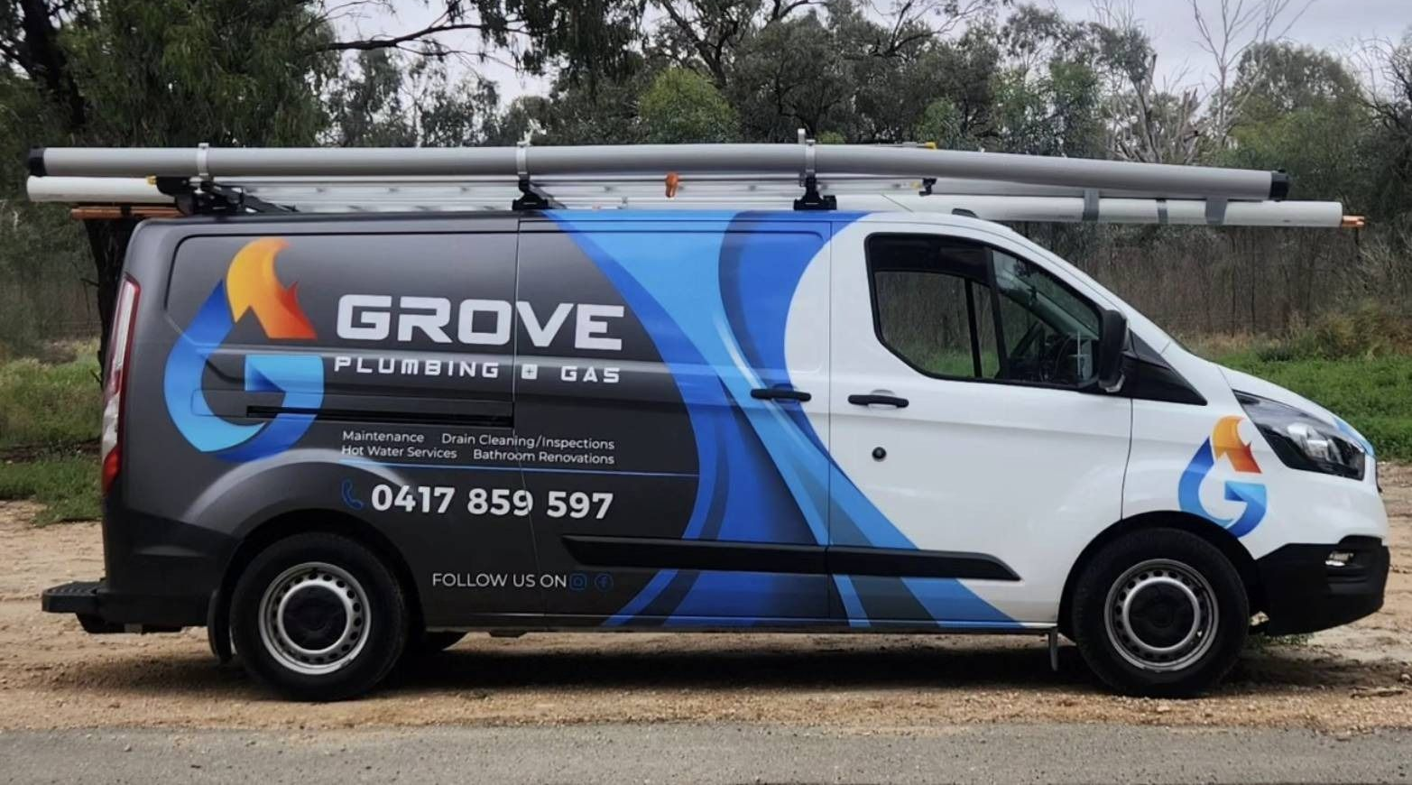 Grove-branded white van with blue and orange graphics parked outdoors, carrying ladders on the roof
