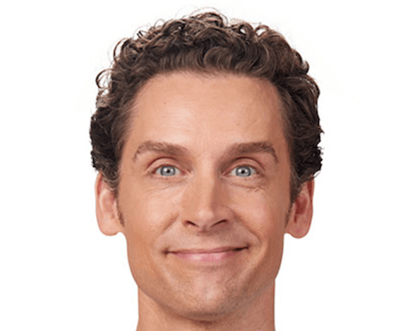 Man with curly brown hair and blue eyes smiling.