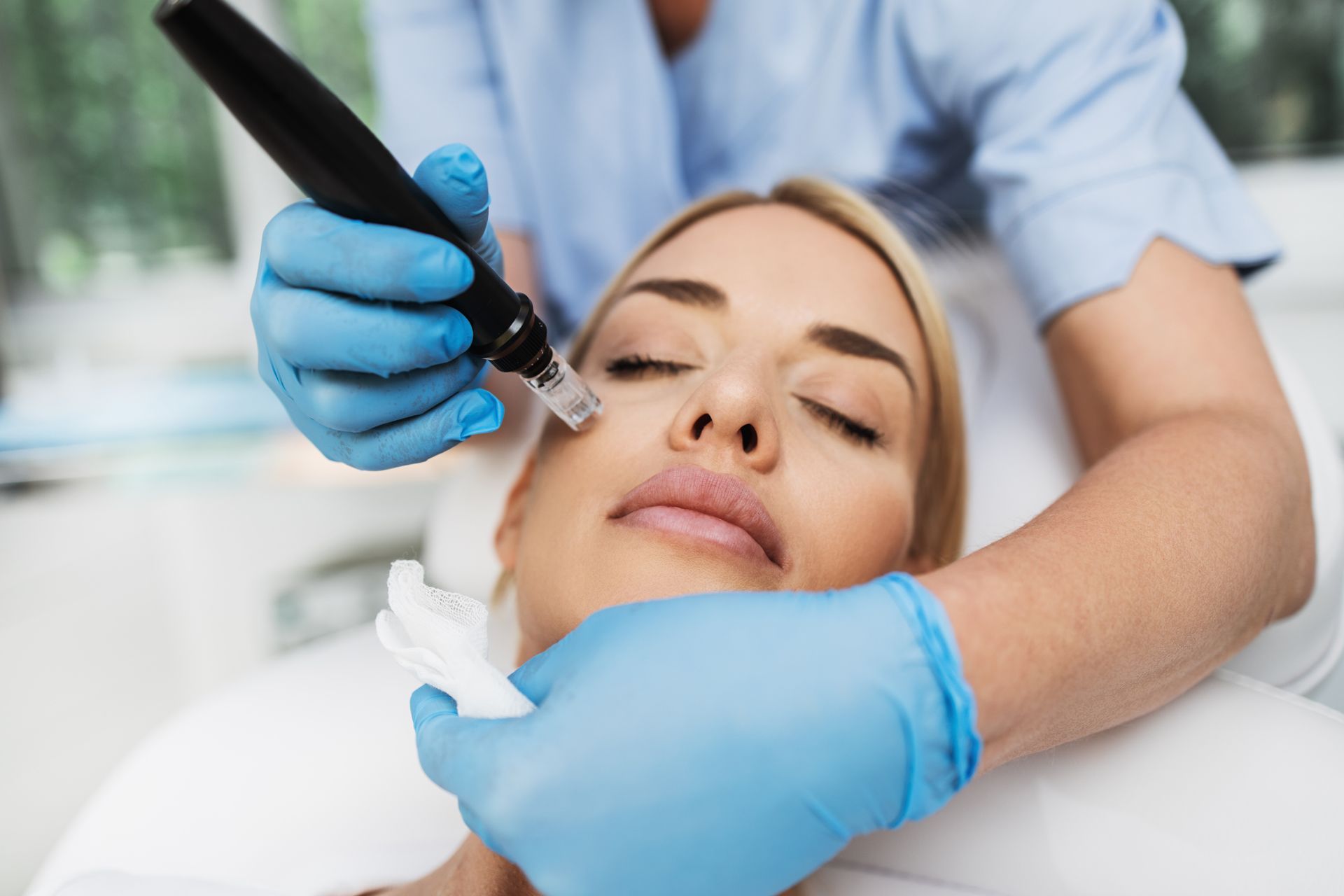 Cosmetic procedure with gloved clinician injecting a woman’s face in a spa setting
