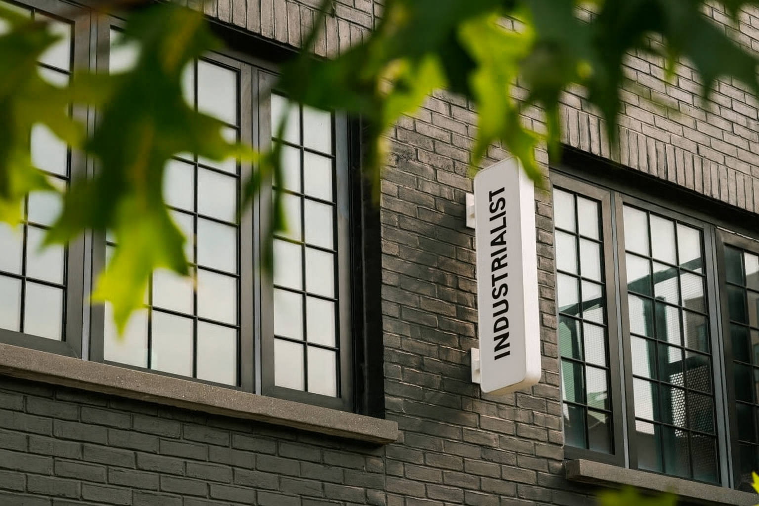 A white, vertical sign reading