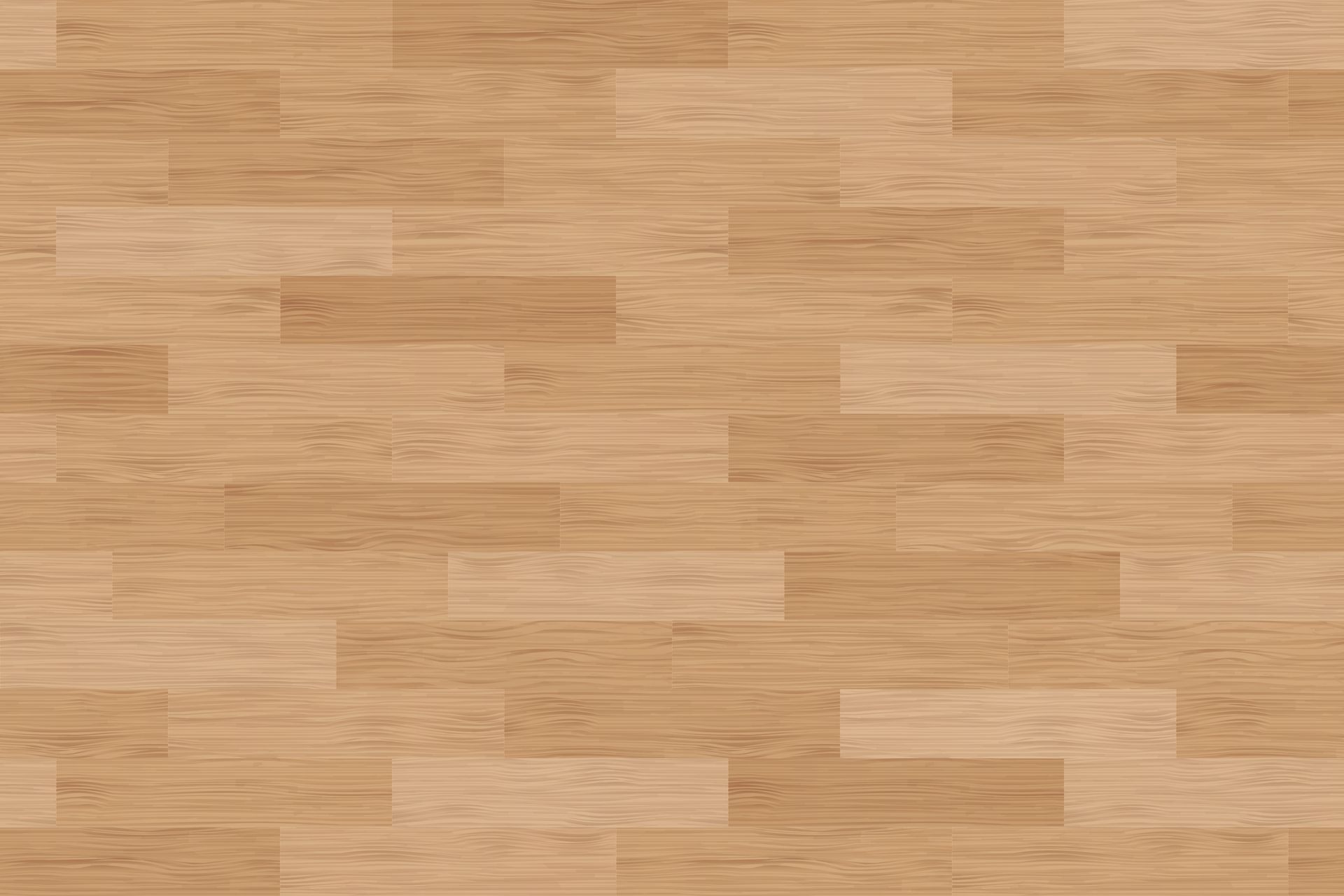A close up of a wooden floor with a basketball court in the background.