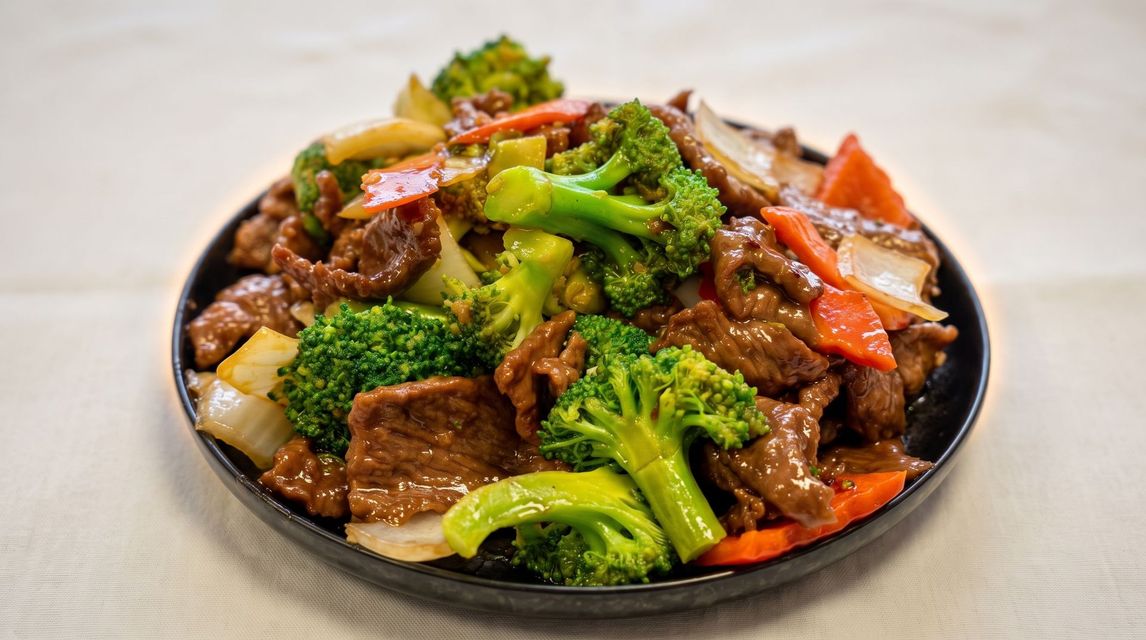 Bowl of beef and broccoli stir-fry with carrots in brown sauce