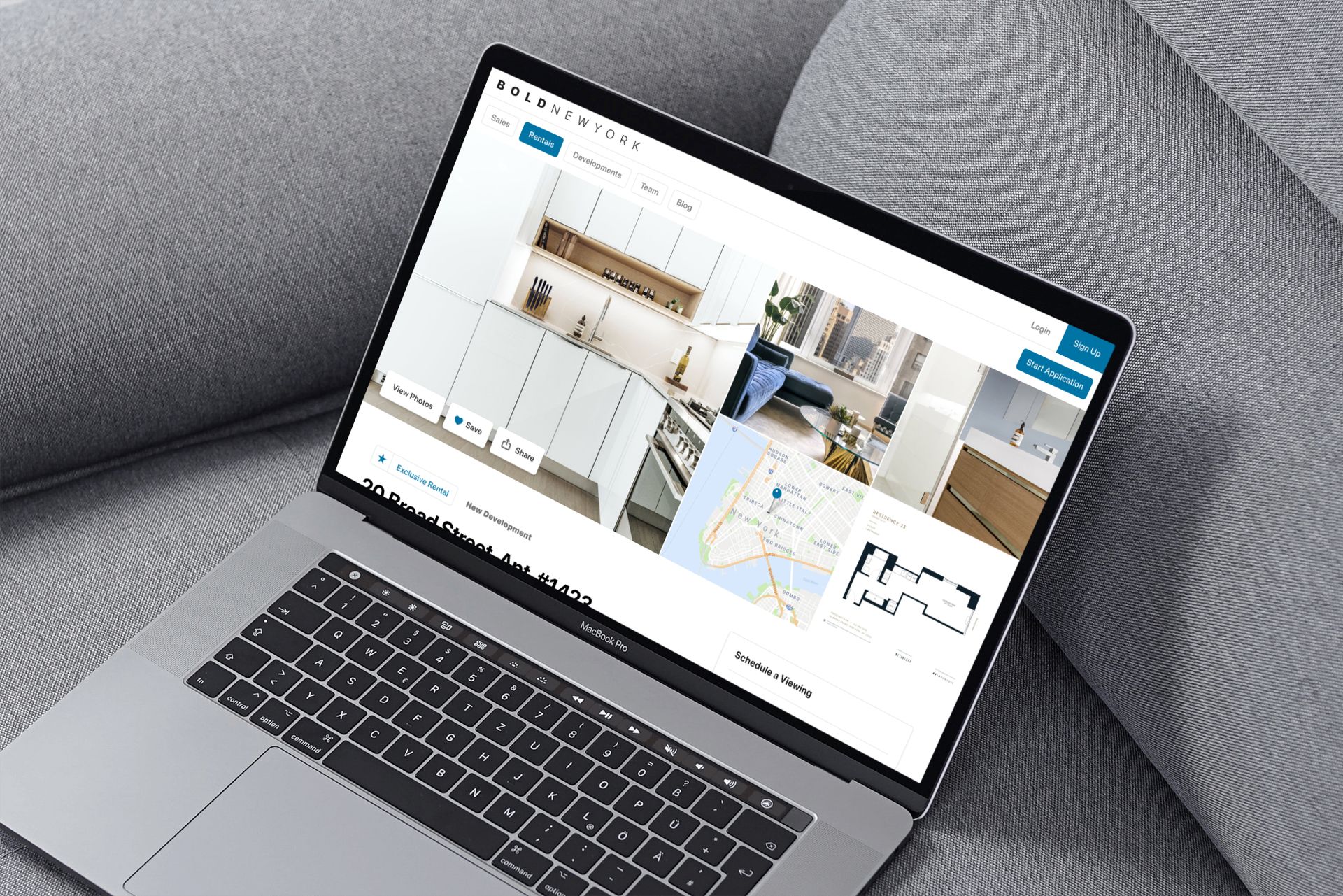 Laptop on a gray couch displays a website with kitchen design images and floor plans.