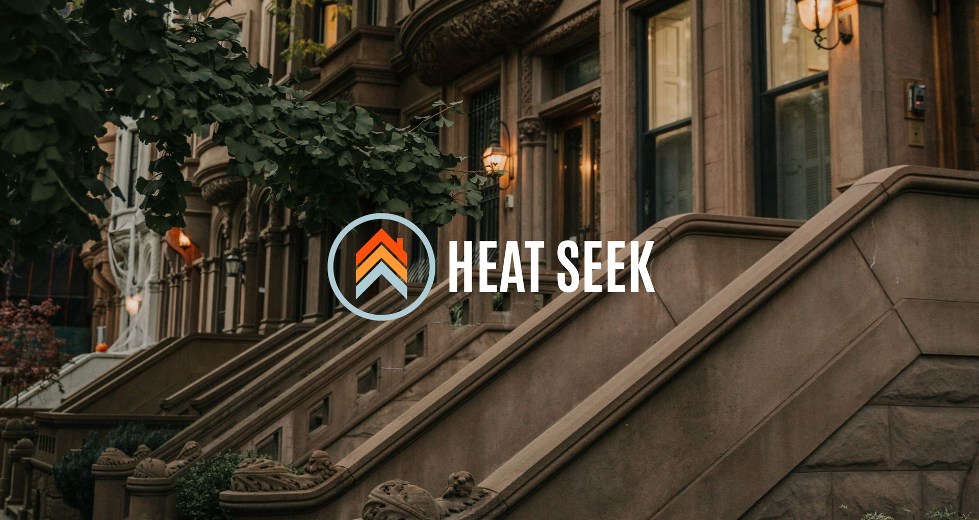 Row of brownstone buildings with stairs; Heat Seek logo overlaid.