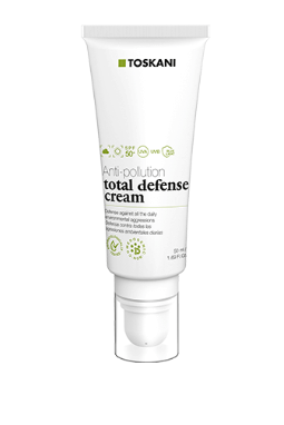 Weiße Tube der TOSKANI Total Defense Creme mit Pumpspender auf einfarbigem Hintergrund