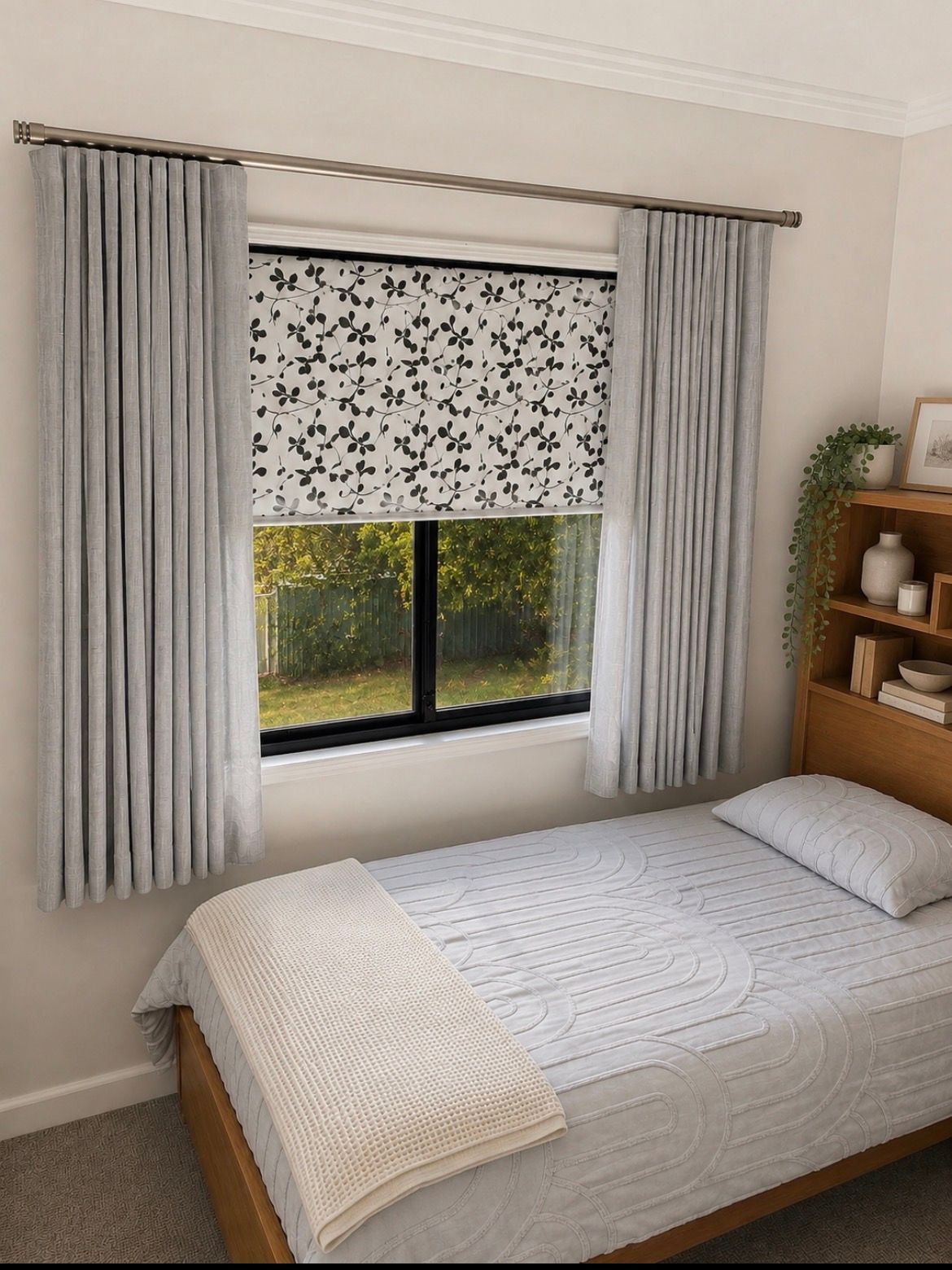 Small bedroom with a bed, window with patterned blind, gray curtains, and wooden shelving— Curtain Concepts in Dunbible, NSW 