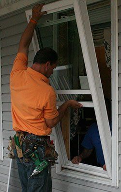 Man Installing Window — Concord, NC — B.W. Larrimore Construction Man Installing Window — Concord, NC — B.W. Larrimore Construction