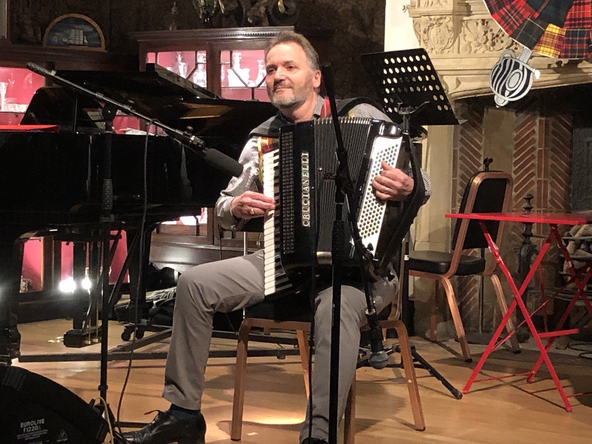 Image of Joint Entertainment Warden, Ian Watts, entertaining on his accordion.