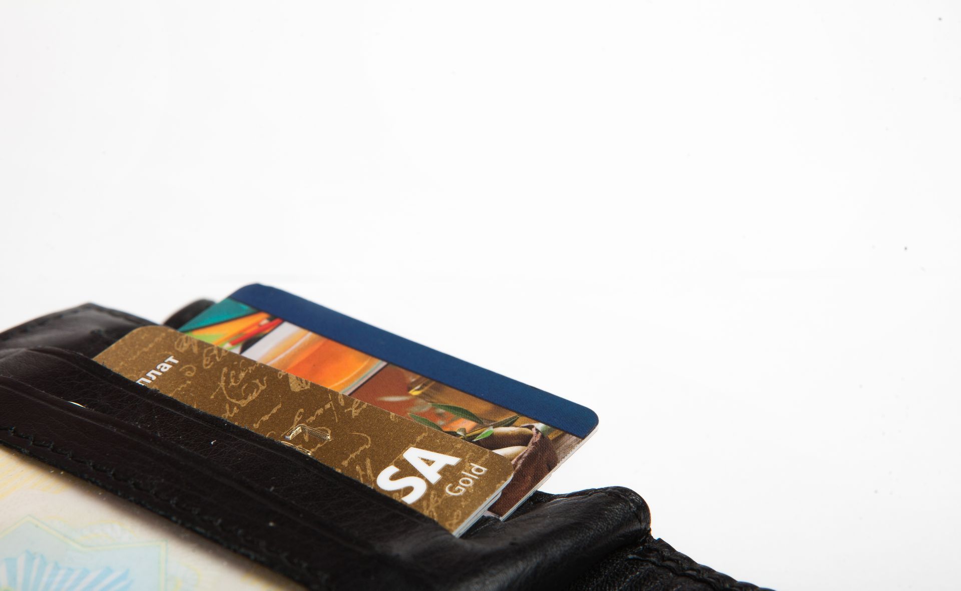 Black wallet with credit cards sticking out, against a white background.