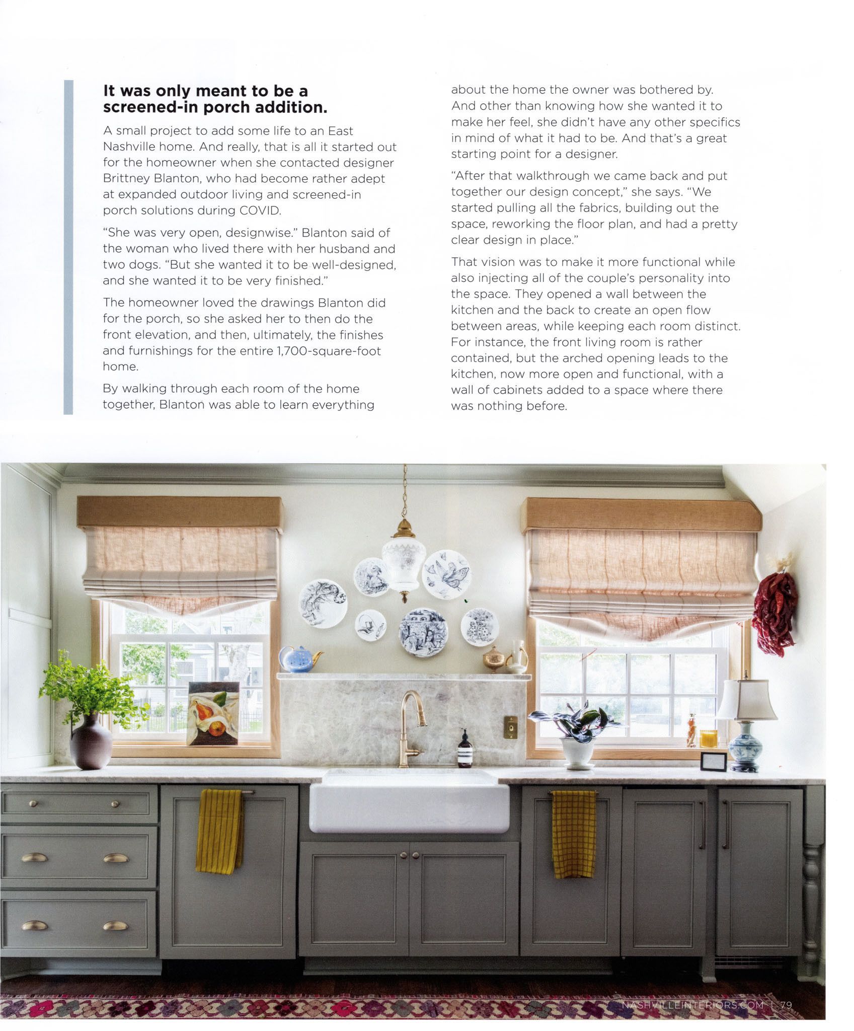 Kitchen with gray cabinets, farmhouse sink, windows with roman shades, and decorative plates.