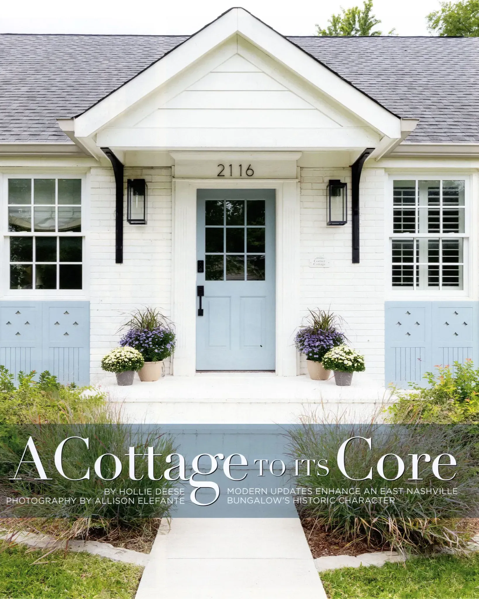 White cottage-style house with pale blue shutters, front door, and flower planters