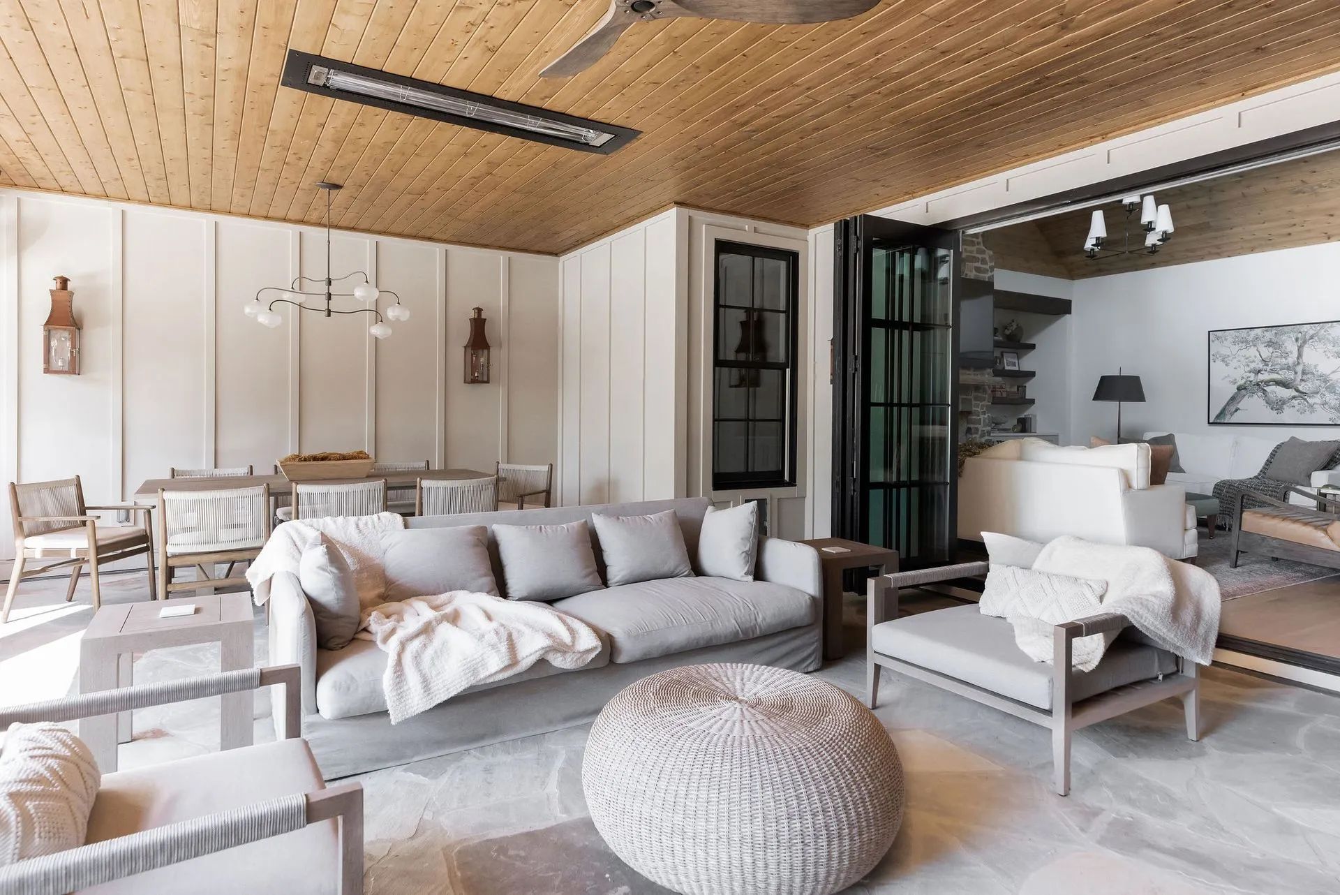 A living room with a couch , chairs , and a ceiling fan.