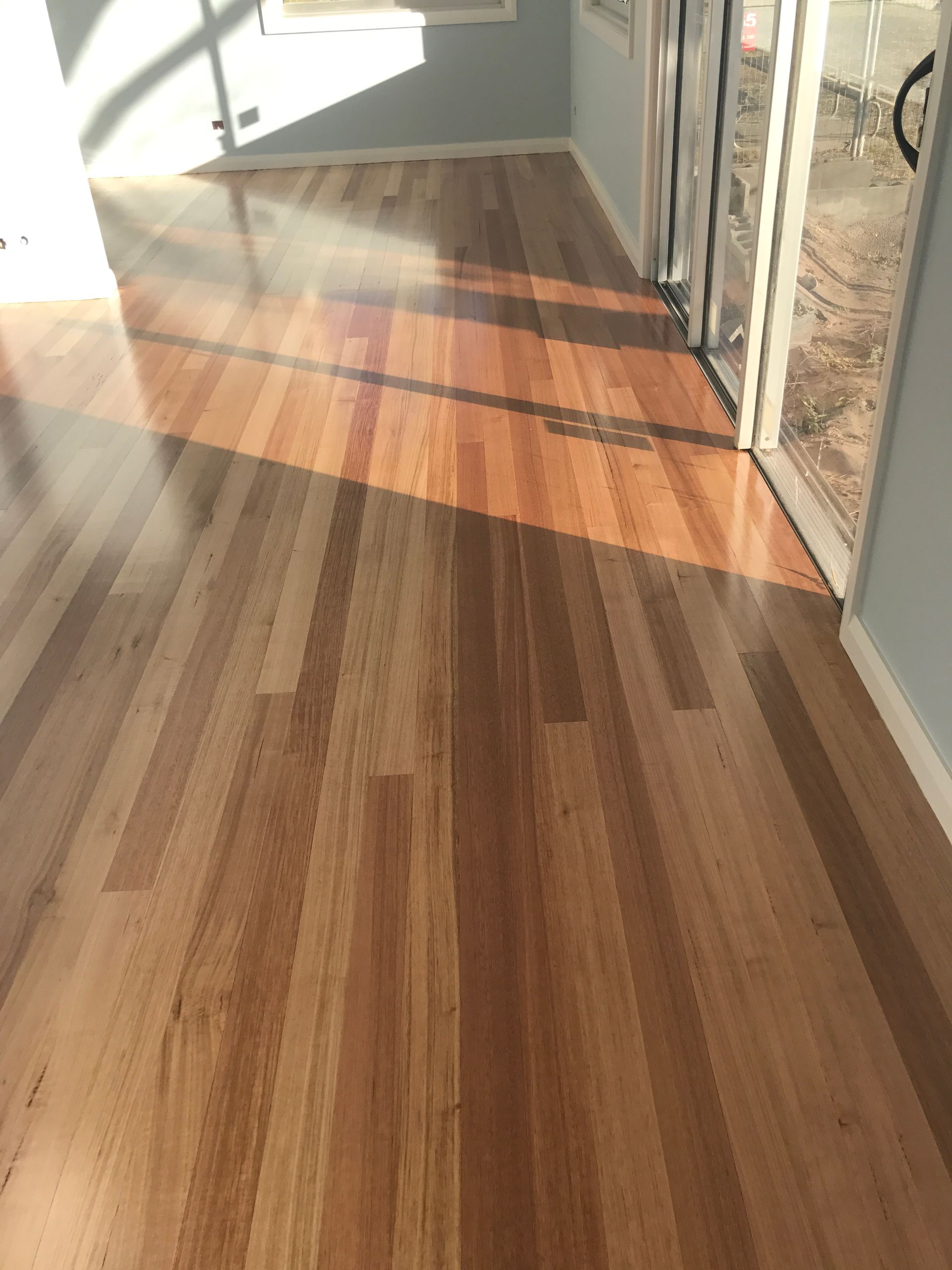 Wooden Floor With Sunlit Streaks — Keystone Property Solutions In Waratah, NSW