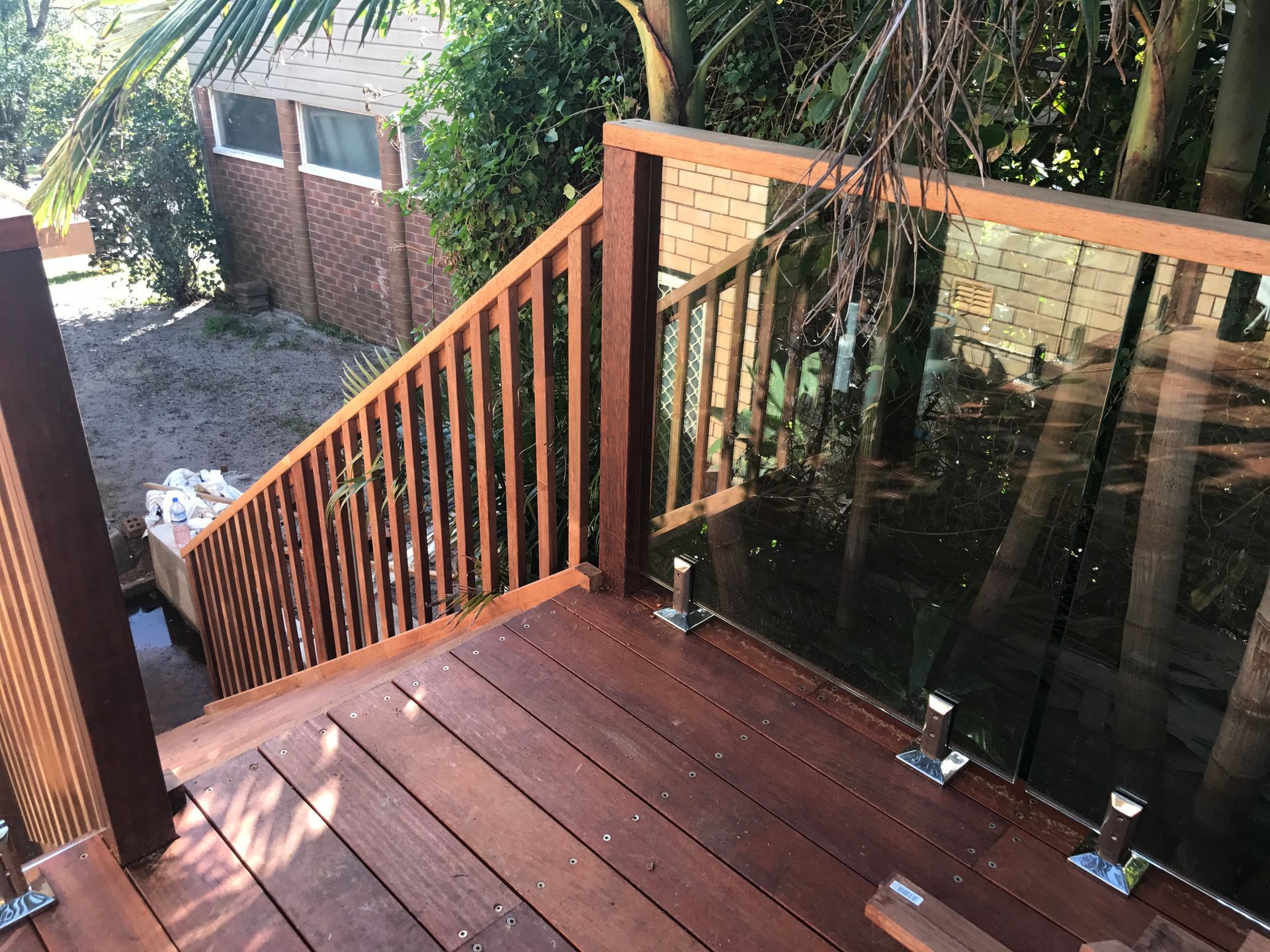 Wooden Deck With Stairs, Glass and Wood Railing, Brown Tones, Outdoor Setting — Keystone Property Solutions In Waratah, NSW