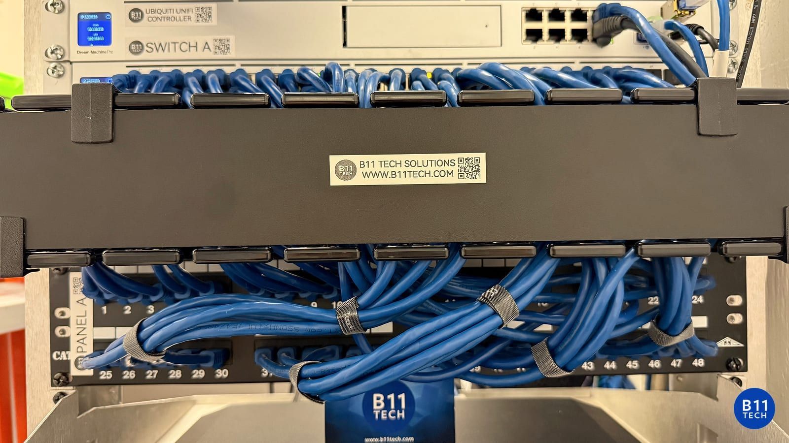 B11 Tech UniFi network rack with labeled equipment and Ethernet cabling supporting Wi-Fi and security upgrades