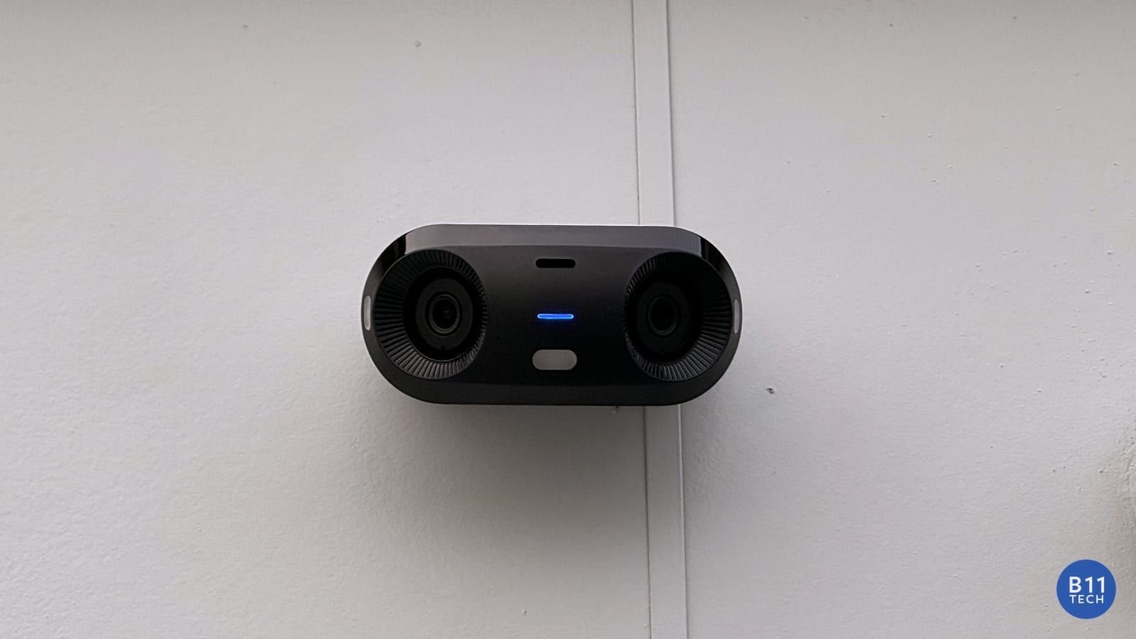 Security camera mounted on exterior siding during a real B11 Tech installation