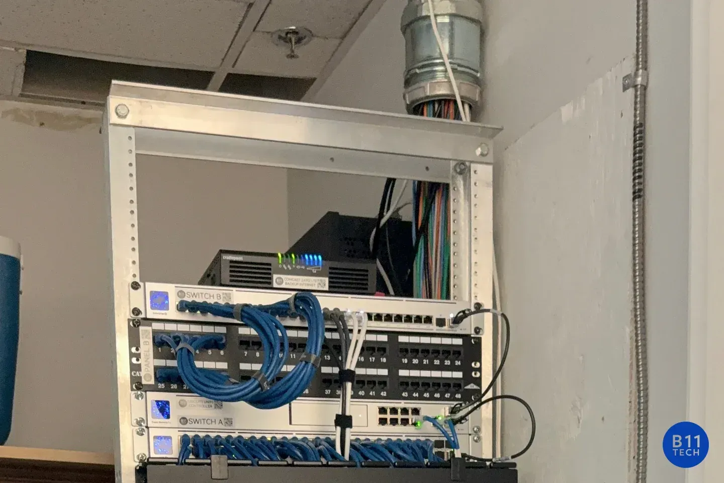 Network switching and patch panels in an installed equipment rack, photographed by B11 Tech.