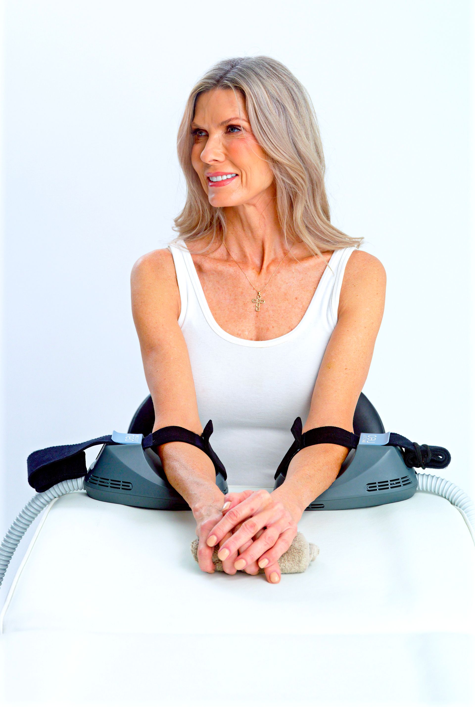 Woman receiving an Emsculpt Neo arm treatment at The Luxe Clinic in Perdido Key, FL