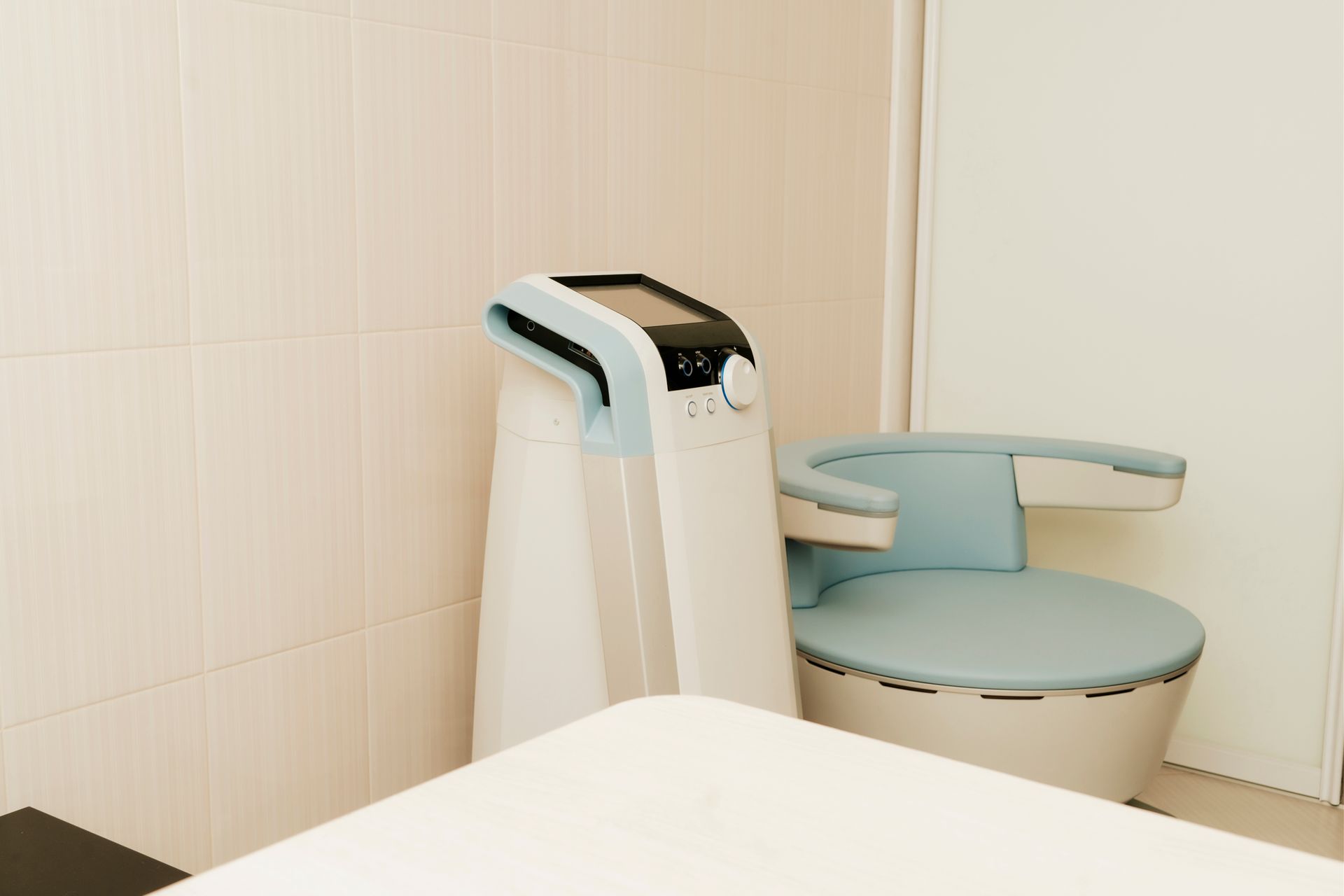 A chair is sitting next to a machine in a room.