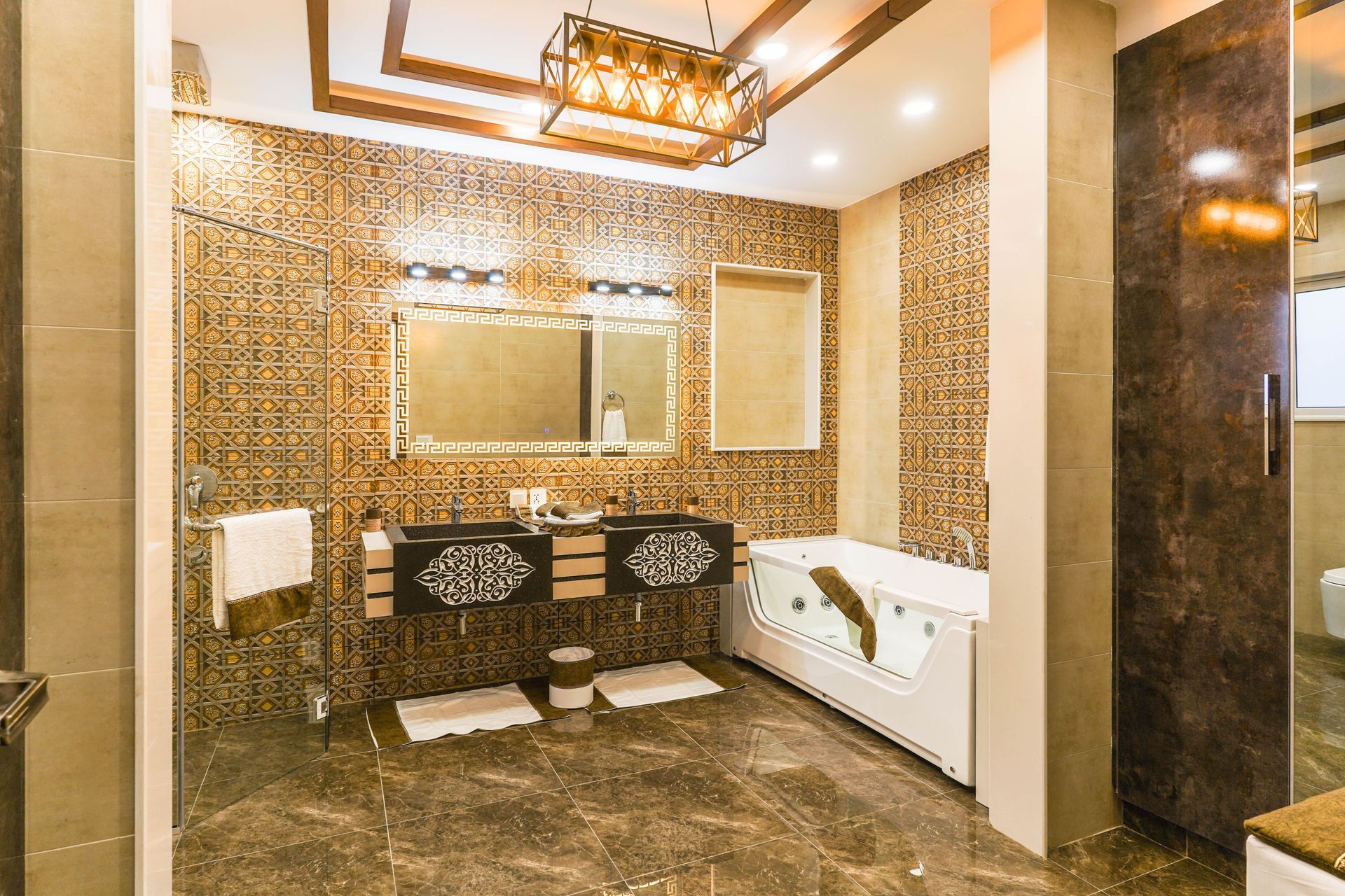 Luxurious bathroom with gold mosaic walls, double sink vanity, large mirror, and white soaking tub