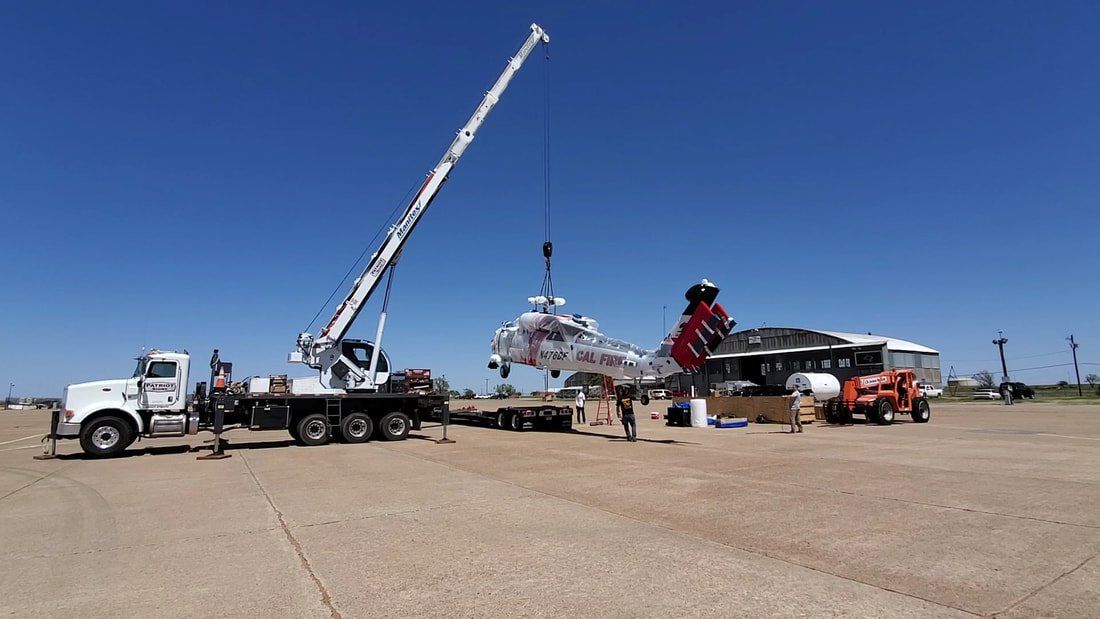 A large crane is being used to lift a large object.