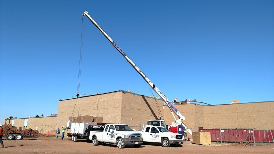 A construction site with trucks and a large crane