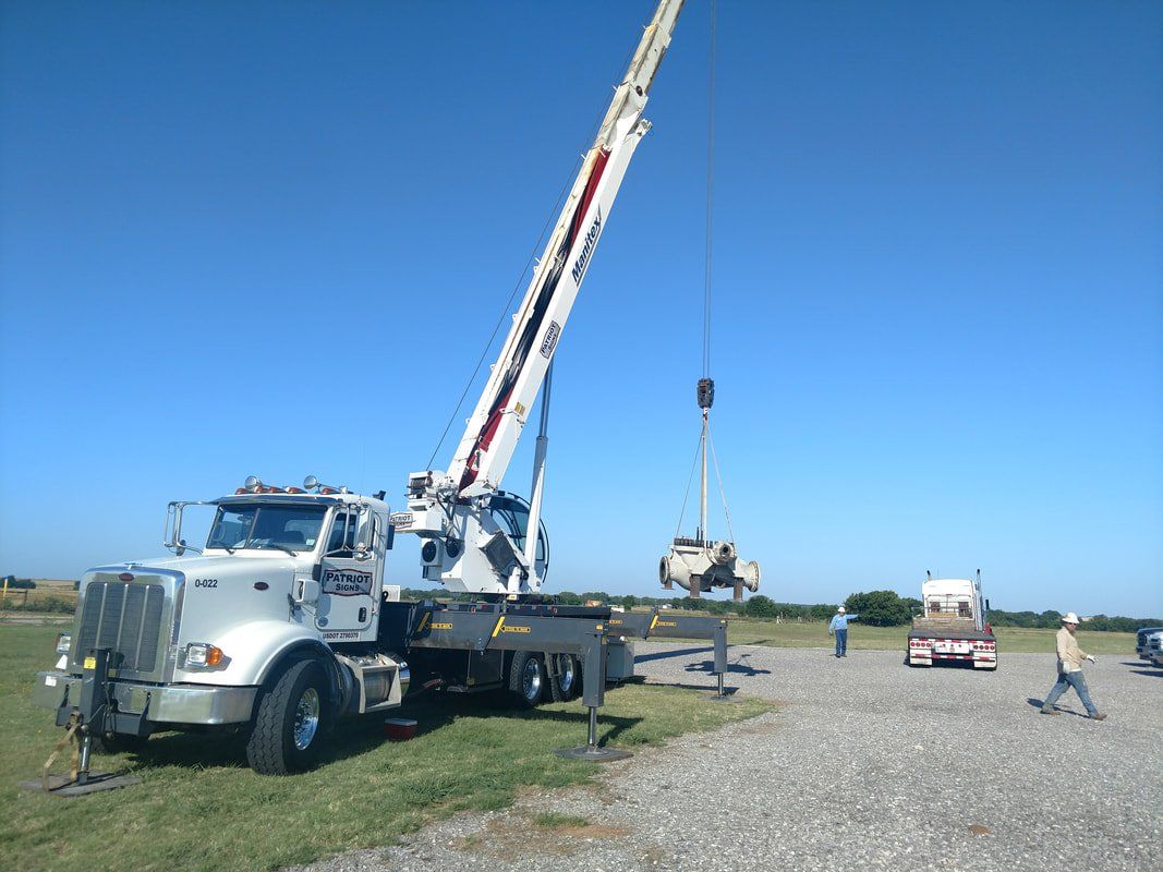 A large white truck with a crane attached to it